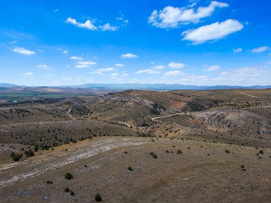 Welcome to 19.85 acres of pristine Montana beauty in the sought-after Gallatin River Ranch community, just minutes outside of Manhattan. This expansive parcel offers the perfect blend of privacy, open space, and access to nature. Bordering a public state section along its northern boundary, this lot offers an extended sense of seclusion and recreational opportunity right out your back door. Gaze out across stunning southwest views that stretch for miles—an ideal backdrop for your dream home, retreat, or investment. The gently rolling terrain makes for a flexible build site, with ample room for horses, outbuildings, or simply room to breathe. Gallatin River Ranch is a private, 5,900-acre community known for its sweeping views, wildlife, and access to the legendary Gallatin River. Residents enjoy exclusive access to a private stretch of the river for fishing and floating, as well as maintained roads, hiking and riding trails, and a nearby equestrian center. With a highly competitive price point and unmatched surroundings, this is a rare opportunity to own a large slice of unspoiled Montana. Don’t miss your chance to be part of this truly special community.