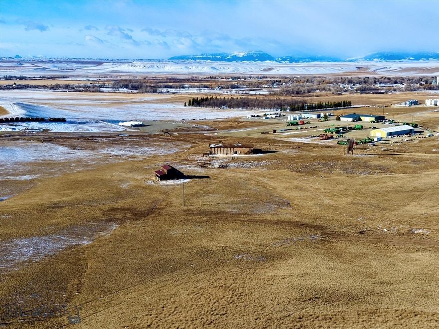 Imagine waking up to unobstructed views of the Rocky Mountain Front stretching endlessly across the horizon. This is the everyday reality that awaits on this exceptional 31.75± acre property on the outskirts of Choteau, Montana. Perched along paved Highway 221, this gently rolling acreage offers elevated building sites that frame the kind of panoramic mountain and countryside views most people only see on postcards. The hard work of getting started is already done — electricity, natural gas, telephone, and city water are all in place, meaning you can focus your energy on building the life you want rather than the infrastructure to support it. The existing large structure presents an intriguing opportunity for those with a creative eye. Restore it, repurpose it, or reimagine it entirely. Few properties offer this kind of built-in potential at this scale. Step off the property and you're already in the middle of one of Montana's most celebrated outdoor playgrounds. The Teton River winds through the region offering world-class fishing for brown and rainbow trout. Teton Pass Ski Resort is just a short drive away, putting a full season of skiing and snowboarding practically at your doorstep. The iconic Rocky Mountain Front — one of the most dramatic landscape transitions in North America — opens into an endless network of hiking, wildlife watching, and backcountry exploration. And when you want the comforts of town? Choteau is moments away, offering restaurants, shops, schools, and community without sacrificing a single acre of that wide-open Montana feeling. The Choteau Airport sits less than a mile from the property line, making this an equally appealing option for those who want easy access without sacrificing remoteness. Properties like this, with legal paved access, utilities, established improvements, sweeping views, and proximity to both town and true wilderness, simply don't come available often. The Front is calling! This is your chance to answer.