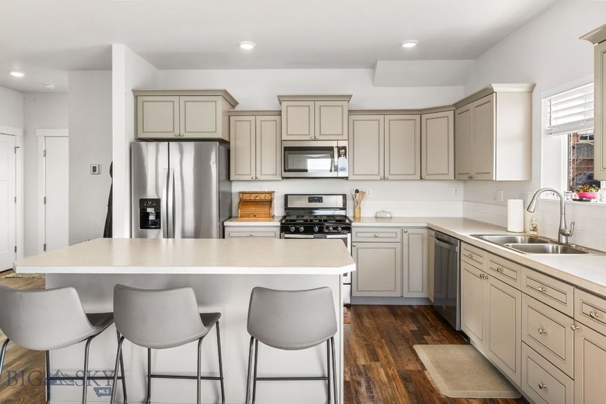 This comfortable townhome has lots of natural light from south facing windows and sits next to subdivision open space. Well-appointed kitchen includes large center island, tile backsplash and stainless-steel appliance package. The living room, dining room and kitchen join to promote an enjoyable atmosphere for gathering friends and family. Sliding door access from dining to extended concrete patio is perfect for grilling.  A vaulted ceiling in the master enhances the spacious feel. Two additional bedrooms are generous in size. Extra space upstairs is a convenient office/workspace. Upgrades include full window treatment package including blackout in bedrooms, central a/c, ceiling fans, glass shower doors and luxury vinyl flooring throughout the main level. Double attached garage offers ample storage space. This is an end unit.