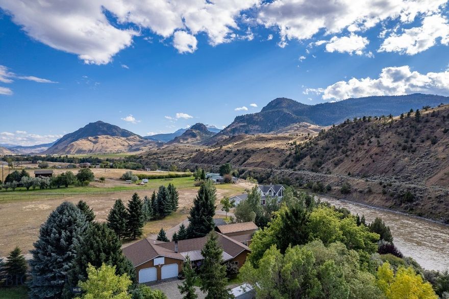 YELLOWSTONE RIVER FRONTAGE! This phenomenal property is a rare find with amazing river frontage located 10 miles north of the world-renowned Yellowstone National Park.  A spacious, one level home with 3BR, 2 baths, an inviting open floor plan, and a private patio overlooking a beautifully manicured tree-lined lawn leading down to the river.   Enjoy a soak in the hot tub under the stars as you listen to the river flow by.  This home has an oversized attached double garage large enough to park full sized trucks/SUVs and still have plenty extra space for storage, freezer, etc.  Plus another large shed to store all of your yard equipment, ATVs, and toys so they aren’t taking up space in your garage.   In addition, there’s another garage/ADU with tiled ¾ bath and full kitchen complete with a triple bay commercial sink, making for the perfect spot to do your home canning, game processing, or any other projects.  It functions easily as guest quarters or as the premier top-of-the-line man cave.  Wildlife visits are common throughout the year, you will see elk, deer, bison, big horn sheep, an occasional bear, and of course all the waterfowl and birdlife known to frequent the Yellowstone River.  This makes for a great retreat, vacation home, or full-time residence.  Perfect for the outdoor enthusiast, this is the ideal base camp situated near millions of acres of Forest Service and all the splendor and beauty of Yellowstone Park.  This place is truly a private oasis in a location that is so incredibly special, you’re sure to be filled with wonder and amazement during every season!