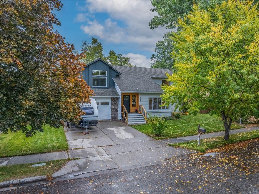 Nestled among mature trees in a quiet, desirable neighborhood, this well-maintained home offers great curb appeal with its sleek Hardieboard siding and Trex front stoop. It boasts a spacious fenced backyard with mature cottonwood trees and flowering crabapple trees. The grass is beautifully maintained with underground sprinklers and a well for irrigation, so yes to a water right and no to an irrigation bill. Great news, the hot tub stays!
You will be so pleasantly surprised with the incredible chef's kitchen. Any chef would hail the Bertazzoni range, complete with a Viking hood and pot filler. The KitchenAid dishwasher is less than a year old, and the refrigerator is Jenn-Air. One bedroom has been conveniently used as a home office. It has gorgeous Bridger Mountain views and is nicely equipped with fiber optic for high-speed internet. The other two bedrooms and two full baths are upstairs as well, and the entire home has new LPV flooring. The owners have made many updates and have loved living here. They take pride in their ownership, as do the neighbors throughout the neighborhood. They appreciate that Valley Unit Park, which is 8.5 acres with playground amenities and a stream, is located across the street behind their neighbors' homes. This house is as cute as a button, so come see it!