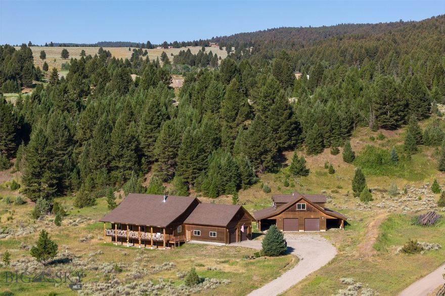 217 Windy Pass Trail offers an optimum Big Sky/Gallatin Canyon location with beautiful views.  Situated on an almost level 3.9 acre lot with a hillside to the west, it is only 2.5 miles from the entrance to Big Sky, 5.5 miles from Town Center, 11 miles from the Big Sky Ski Resort, and 18 miles from the Yellowstone Park line.  It is within walking distance of Ophir School and the Warren Miller Performing Arts Center and the Gallatin River.  Whether you are an avid skier, fisherman, hiker, mountain biker or all around outdoor enthusiast, this is the place for you.  4 horses may be kept on the property from May 1 to November 1.  The main house with a 2 car garage consists of 4000 sq. ft. on two levels.  The upper level has 2 bedrooms, including the primary bedroom, an extra room currently used as the laundry room, 2 baths, a large kitchen and great room.  High ceilings and picture windows create an open and airy living space while knotty pine walls and a wood stove add warmth.  The spacious kitchen with rough sawn pine floors, a huge center island and expansive countertops is welcoming and a favorite gathering spot.  Walk out on the large front deck, accented with burl wood and an antler railing, and take in the spectacular views of the Porcupine Wildlife Management Area!  Elk and deer are frequent visitors.  The partially finished lower level has 2 more bedrooms, an extra room, a bathroom and a large unfinished rec room.  The rec room is framed, insulated and the electrical is roughed in.  A detached 2 car garage with a large shop area and an upper level ADU expands living space further.  The finished 1280 sq. ft. ADU is perfect for guests or as a rental.  Two large parking bays have plenty of room for all of your toys.  Move in and make this your own!