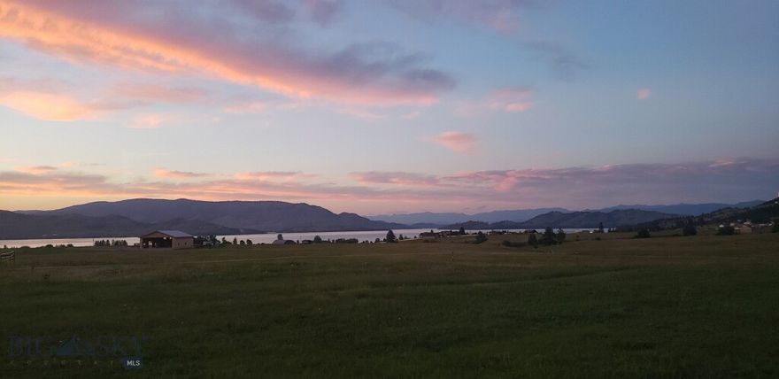 Owner Financing Available! Discover 20.20 acres of spectacular Montana landscape with sweeping, unobstructed views of Flathead Lake, Wild Horse Island, the Mission Mountains, and Chief Cliff. This level, highly usable parcel offers no HOA and no CCRs, providing true flexibility to build your dream home, keep horses, or create a private retreat. A seasonal creek enhances the natural setting.

The property is well-prepared with 200-amp power, a meter box, and a 30-amp RV plug. Included is a 2005 Sandpiper travel trailer and Starlink internet, ideal for weekend stays or living on-site while you build. Conveniently located just minutes from Polson and Kalispell, and only ¾ mile from Big Arm State Park with a public boat ramp, this property offers year-round recreation with easy access to the lake and nearby ski areas. Motivated seller—don’t miss this rare opportunity.