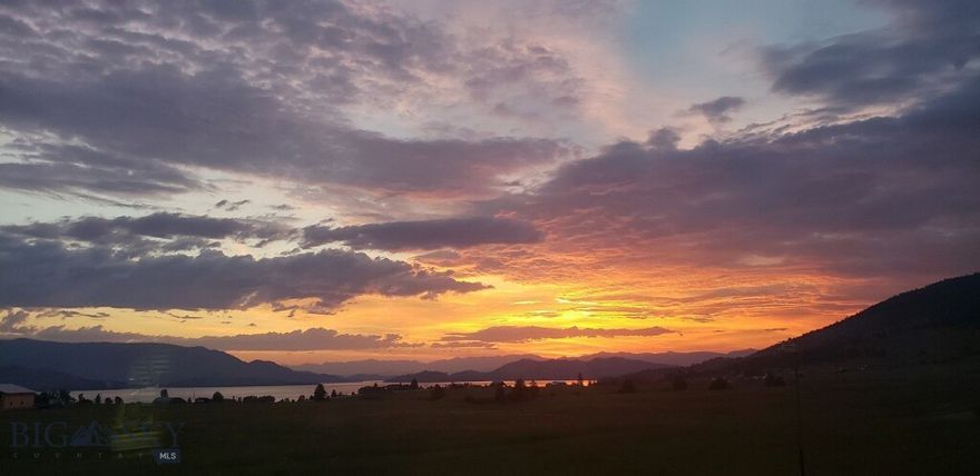 Owner Financing Available! Discover 20.20 acres of spectacular Montana landscape with sweeping, unobstructed views of Flathead Lake, Wild Horse Island, the Mission Mountains, and Chief Cliff. This level, highly usable parcel offers no HOA and no CCRs, providing true flexibility to build your dream home, keep horses, or create a private retreat. A seasonal creek enhances the natural setting with transferable water rights. The property is well-prepared with 200-amp power, a meter box, and a 30-amp RV plug. Included is a 2005 Sandpiper travel trailer and Starlink internet, ideal for weekend stays or living on-site while you build. Conveniently located just minutes from Polson and Kalispell, and only ¾ mile from Big Arm State Park with a public boat ramp, this property offers year-round recreation with easy access to the lake and nearby ski areas. Motivated seller—don’t miss this rare opportunity.