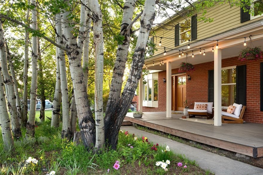 Bright, airy and full of life, this Southside gem has all you need to thrive in Bozeman, with INCOME POTENTIAL! Opportunity for over 8% CAP rate! 5B|2.5B PLUS lower level full bathroom & kitchen studio apartment is on 0.59 acres of level, green lawn and mature trees on a corner lot. Enter the home from the wide, welcoming front porch and you'll find natural light flooding in across hardwood floors. The living room beckons with the white brick wood-burning fireplace and extra large glass doors to the deck. Additional front family room has a 2nd fireplace with wood-stove insert & could double as a media room or home office for a dreamy work/school from home set-up. Live outside all summer long with morning coffee on the porch, lawn games, trampoline and sprinkler fun, and grilling out on the back patio while relaxing as you watch the sun go down. Immense back yard is a dream for dogs and kids of all ages: fully fenced and lush lawn will keep them happy until the dinner bell rings. Adorable barn-style shed makes a great gardening center, play house, backyard artist's retreat! Upstairs, the primary suite has 2 closets, tiled shower and large windows overlooking the front aspen grove & side yard. 4 additional guest rooms & full bathroom upstairs are great for families to stay together on the same level or for roommates to keep bedrooms private when entertaining in the rest of the house. Lower level studio apartment has a side entrance, full kitchen, full bathroom, open floor plan with wood fireplace & 2 additional rooms (non-conforming bedrooms). Great to keep as income-producing rental, generational living, or additional living & working space. 2 blocks to Tuckerman Park & Bozeman (Sourdough) Creek trail, and with multiple trailheads to access the Gallatin Mountains just down the road, you'll never run out of ways to stay active right from your front door! Hit Sourdough Trail & Main Street to the Mountains Trails to get to school, work or to meet friends downtown. Parking pad behind a gate from the side street provides out-of-the-way storage for RVs, raft/snowmobile trailers, additional cars. Healthy, mature trees surround the homes in this area, giving you a colorful and private landscape. County zoning/taxes with well & water rights, yet excellent in-town location for easy access via car or trails to MSU, Hospital, grocery store, Bozeman schools, restaurants, Main Street shops and businesses.