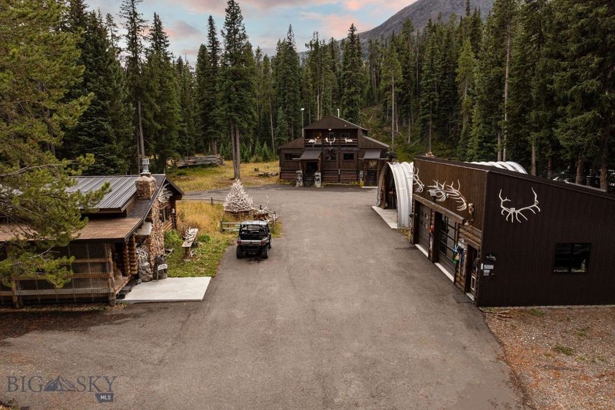 Welcome to Wildflower – Cooke City, a rare and versatile mountain retreat featuring two beautifully appointed dwellings on a breathtaking property bordering National Forest land with creek access. Perfectly situated just 7 miles from the Northeast Entrance of Yellowstone National Park, this one-of-a-kind offering provides unmatched access to some of the best snowmobiling, backcountry skiing, hiking, hunting, and fishing in the Rocky Mountains. The primary residence is a 1,671 sq ft, 3-bedroom, 3-bathroom home, originally built in 2000 and tastefully remodeled with a refined rustic charm that perfectly complements its alpine surroundings. Offered fully furnished, the home has been successfully operated as a short-term rental known as “Wildflower – Cooke City”, making it an excellent opportunity for both personal enjoyment and income potential. The second dwelling is a single-level, 1,148 sq ft log home featuring 3 bedrooms and 3 bathrooms. Warm, inviting, and authentically Montanan, this home offers additional living space for family, guests, or rental flexibility. Complementing the residences are exceptional outbuildings, including a 780 sq ft heated shop with two 10’x10’ overhead doors—perfect for vehicle or snowmobile storage—and a 900 sq ft Quonset metal building with a concrete foundation and power, ideal for equipment, gear, or hobby use. Whether you’re seeking a primary residence, investment property, or a mountain escape, this property delivers endless possibilities in a location that truly captures the spirit of Montana’s wild beauty—steps from the forest, minutes from Yellowstone, and surrounded by adventure in every direction.