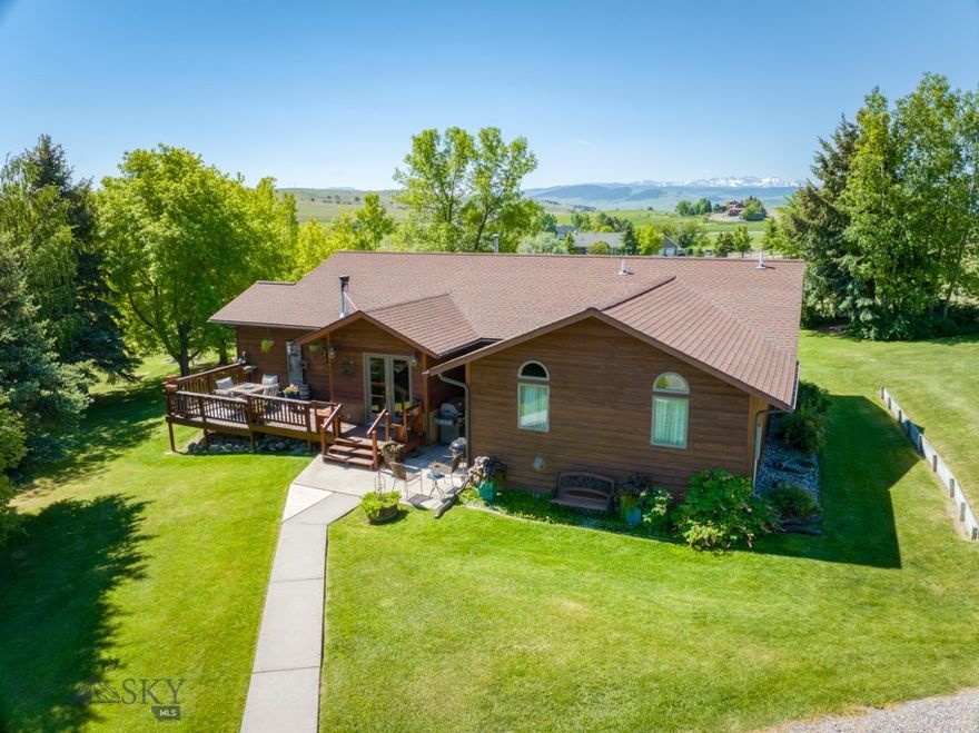 This beautiful, custom-built home on 6.5 acres is truly everyone's dream, and offers so many extras that most places don't! Manhattan address, but closer to Bozeman and in Bozeman schools! The home features 2052 square feet of living space, with hardwood flooring, vaulted ceilings, granite countertops, a propane fireplace plus another propane freestanding stove, a large deck, central air conditioning, and dreamy views! The floorplan is versatile, with one side housing the guest room, guest bath, and a flexible family room/den (with a freestanding propane stove and new barn doors) that could easily be transformed into a third bedroom if needed (just add a closet!) On the other side of the home, you'll find the primary bedroom with en-suite bathroom and walk-in closet, a large laundry room, and a walk-in pantry. The heart of the home includes the entryway, featuring a woodburning stove to take the chill off in the winter, an open kitchen/dining area with granite countertops, newer stainless steel appliances, and a breakfast bar, and a lovely vaulted living room with a cozy propane fireplace. But, you may never want to go inside, because the massive yard is gorgeous and offers so many extras! Fully fenced for dogs, the yard has underground sprinklers and a remote-controlled gate for the driveway. And there are 4 outbuildings: a 26x36, 3-car garage with an additional 10x12 work area, a 20x24, 2-car garage/shop, a 20x32 building with a crawl space, wood stove, air conditioning unit, and 220 power -- perfect for woodworking, artist studio, guest house (with revisions) or whatever else you may dream of! Last, but certainly not least, is the 24x30 commercial grade greenhouse, featuring heating, a fan system, Enviro system, its own propane tank, and a watering system -- what an amazing opportunity to grow your own produce, flowers, or possibly enough to wholesale to others! But wait, there's more! The incredibly large "forest" of trees is almost 30 years old, and gives you a true retreat -- or a great place to build forts and treehouses! The large garden has just been planted, and will produce a great harvest this fall! And there is still about 4.5 acres of pasture land ready for your livestock -- up to 4 horses, cows, or llamas are allowed here! As a bonus, there are 2 wells -- use one for irrigation & backup, one for the house. Less than 30 minutes to Bozeman, close to blue ribbon fishing rivers, mountain trails, and everything that Montana has to offer!