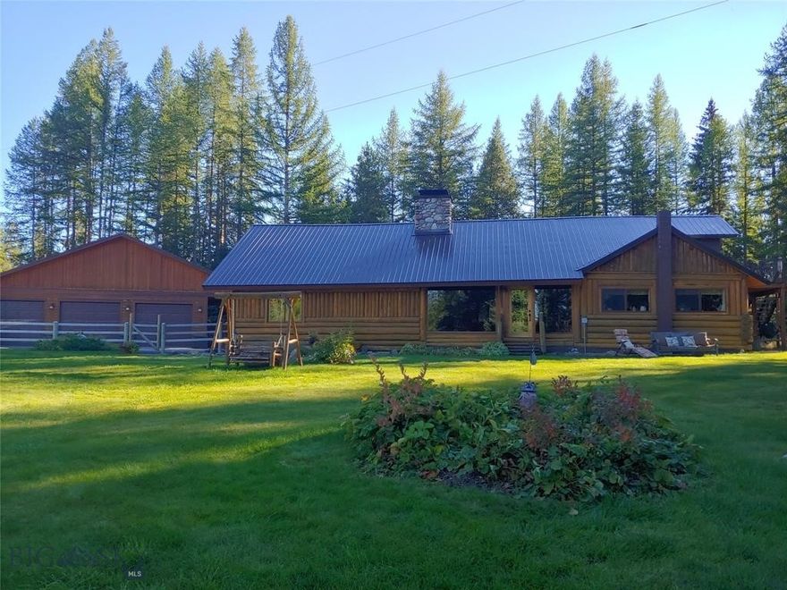 New metal roofing! Welcome to this beautiful 4bed, 3ba log sided home on 3.9 acres. This warm and inviting home has been meticulously maintained and beautifully kept. The wooden floors throughout the main living areas are original and lend to the charm of the home. A floor to ceiling rock fireplace is not only stunning showpiece but extremely functional, radiating heat from the stones for up to 8 hours after the fire is out. There is built-in water feature on the face of the fireplace. Just off the living area is a spacious kitchen and dining area, a full bath, large mudroom/laundry/pantry and a charming upstairs bedroom. On the other end of the home is the primary bedroom, with fireplace, full bath and two more bedrooms upstairs as well as as bonus/storage room and a 3/4 bath just off the main entry. Small dry cabin, fenced for horses, horse run-in, tack area, 3 car garage, well house, hot tub and direct easement access to Forest Service lands to the South. Too many amenities to list!