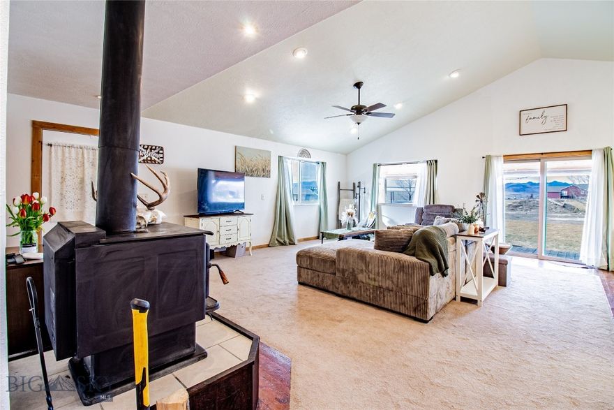 Single-level Montana living in Jefco Sky Park with a huge shop, room to spread out, and a setup perfect for toys, hobbies, storage, or serious workspace. Built in 2008, this 3 bed, 2 bath home sits on 1.17 acres and includes a massive 900 square foot shop. Recent improvements include a new driveway, patio, landscaping, underground sprinklers, propane tank, privacy fencing, updated interior lighting and paint, and a newly finished mud room. Inside, the vaulted great room brings together the living area with a stove, dining space, and kitchen with an island for extra seating and counter space. Down the hall, you’ll find two guest bedrooms with large closets, a full bath, laundry room, and a spacious primary suite with two closets and a large full bathroom. The shop offers excellent space, tons of natural light, and plenty of overhead lighting. The neighborhood itself is one of a kind, with its own private landing strip and many homes with private hangars, though owning a plane is absolutely not required to enjoy living here. And the views? Incredible.