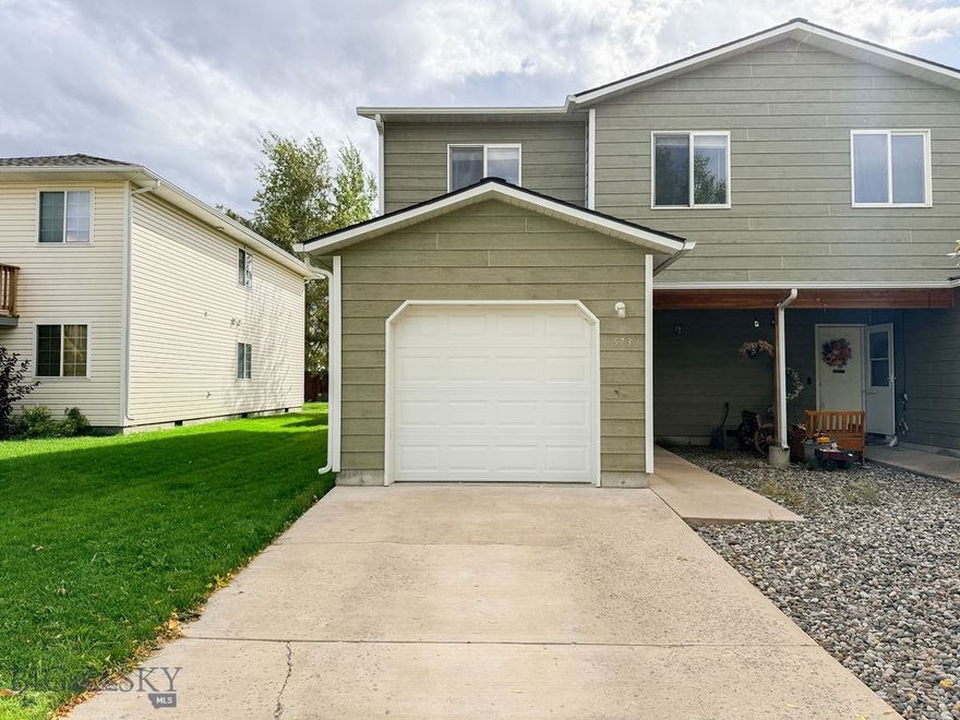 Charming and well-maintained 3-bed, 2.5-bath end-unit, in the heart of River Rock! This 1,311 sq/ft home features an open-concept main level with a bright kitchen, farmhouse sink, and spacious living/dining area. Upstairs offers a large primary suite, two guest bedrooms, and another full bath. Enjoy a fenced backyard, concrete patio, and attached 1-car garage. Great natural light, added privacy, and easy access to parks, trails, and Gallatin River. HOA covers water, sewer & more. Move-in ready and minutes from Bozeman!