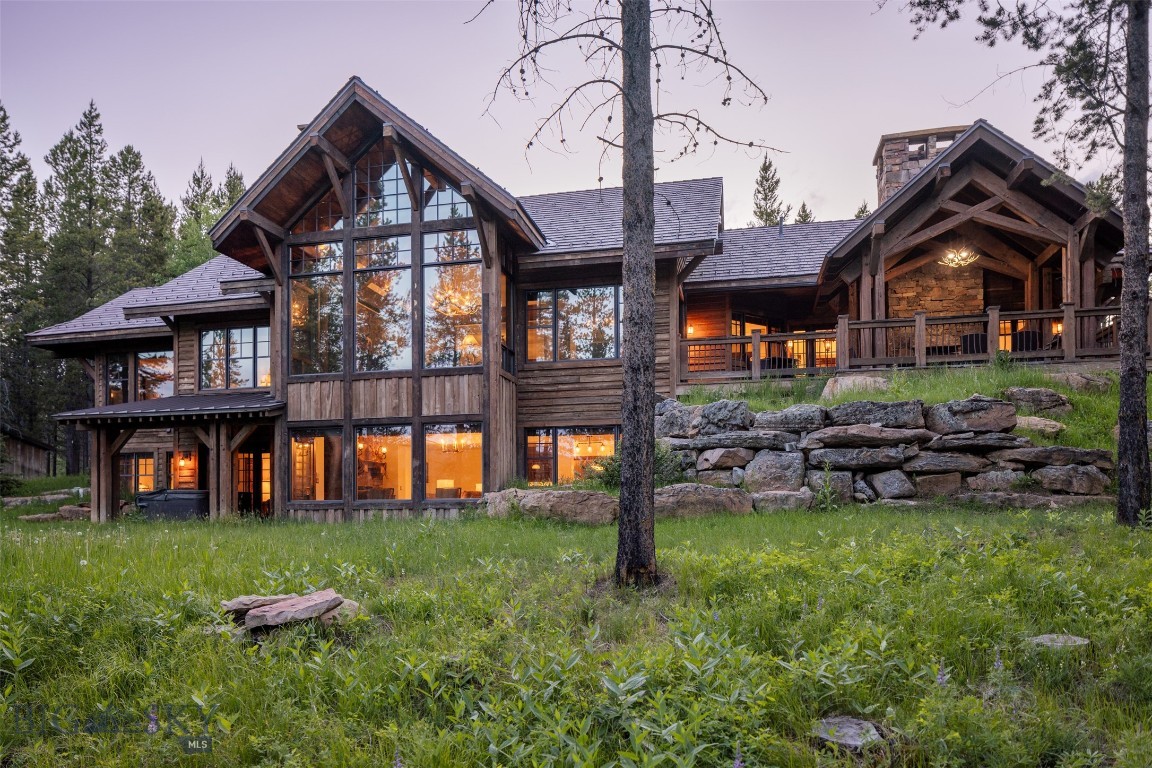 Exquisitely Maintained Timber-Framed Home with Luxurious Finishes and Impressive Features Nestled on 2.18 private acres, this stunning timberframed home blends rustic charm with refined elegance. Fully furnished and meticulously maintained, it offers exceptional living spaces designed for
both relaxation and entertaining. With a total of 5 bedrooms and 5 1/2 bathrooms, this home is perfect for those seeking comfort, sophistication, and
ample space. Main Level: The main floor showcases a spacious primary suite, featuring a luxurious en-suite bathroom and a walk-in closet. Adjacent
to the primary suite is an executive office, perfect for remote work or personal use. The open-concept living area is anchored by a floor-to-ceiling
stone wood-burning fireplace, adding warmth and character to the space. Large windows provide an abundance of natural light and views of the
surrounding landscape are primarily to the East, ensuring morning sun and evening sunsets. The custom kitchen is a chef’s dream, complete with high-end appliances, beautiful cabinetry, and a wet bar ideal for entertaining. The dining area seamlessly flows from the kitchen and living room, creating an inviting atmosphere. Step out onto the expansive deck, complete with an outdoor wood-burning fireplace—perfect for enjoying cooler evenings or gathering with friends and family. Lower Level: The walk-out lower level is designed for both relaxation and entertainment. A large family room provides ample space for lounging and hosting, while the glassed-in wine cellar adds a touch of sophistication. Fitness enthusiasts will appreciate the workout room, and the level also includes 2 bedrooms and 2 bathrooms, providing ideal accommodations for guests or family members. Upper Level: Above the large 3-car garage, you’ll find an additional private living space, featuring 2 en suite bedrooms and a cozy living
room, perfect for guests or extended family. Additional Features: 2.18 acres of serene, wooded property offer privacy and tranquility, with ample space for outdoor activities. Golf membership is available upon club approval, with a deposit due by closing—adding another layer of exclusivity and luxury to this already exceptional property. This home is a rare opportunity for those seeking a truly special place to call home. Offered fully furnished
with a golf membership opportunity for the buyers.
