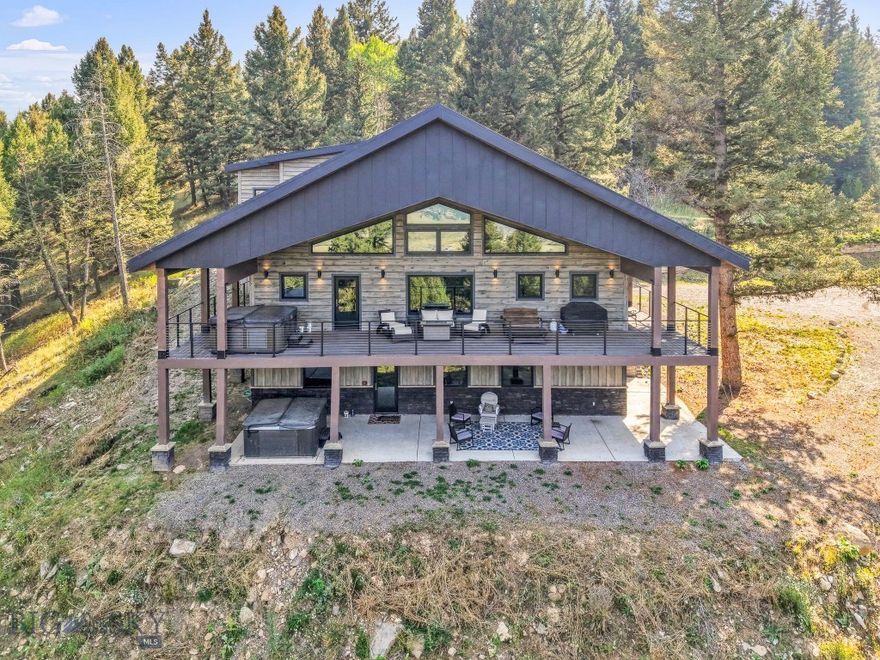 Set atop a hill on over 11 private, wooded acres, 454 Grouse Ridge is the ideal Big Sky retreat that combines privacy, views, and convenience — just minutes from the heart of Big Sky, and the Gallatin River. 

The open-concept main level features a beautiful fireplace, open seating and dining area as well as a custom kitchen with high end appliances. Best of all, the massive windows frame some of the most stunning mountain and river views the area has to offer. A large covered balcony extends the living space outdoors and creates a seamless connection to the setting that can be enjoyed year-round. The main level also features a large primary bedroom and ensuite bathroom as well as a second bedroom that currently serves as a bunk room with it’s own door out to the wrap-around balcony. 

The lower level offers two additional ensuite bedrooms, a second full kitchen and second laundry room as well as a spacious living area. The space is ideal for family and friends who value privacy, or as a lock-off rental option. Positioned into the hillside, the lower level offers walk out access to a second hot tub and abundant natural light. 

Upstairs, a large bonus room with full bath, kitchenette, and private entrance adds even more flexibility for family, friends, or long-term guests. Think: game room, bunk room, home theatre - the possibilities are endless. 

The home is being offered fully furnished and turn-key, allowing you to settle in immediately or begin generating rental income right away. With incredible views, abundant wildlife, unmatched privacy, and a flexible floor plan on 11 acres, 454 Grouse Ridge is a truly unique retreat that captures the best of the Big Sky lifestyle.