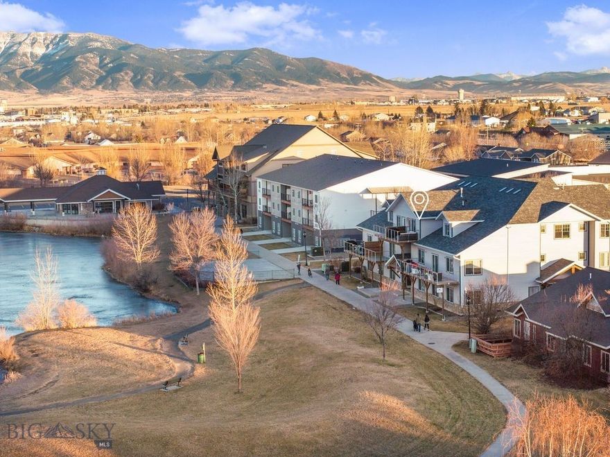 Welcome to 129 Village Drive, Suite 301B, a beautifully updated 760-square-foot, one-bedroom, one-bath condo in the River Rock community. This third floor, light and inviting unit captures exceptional views of River Rock Pond and the stunning Bridger Mountain Range. Views from the bedroom, living space and the private balcony, the perfect place to enjoy Montana’s expansive skies and peaceful waterfront setting. While the unit features north-facing windows and softer natural light, the bright interior finishes, fresh paint, and updated flooring create a clean, airy feel throughout.

The owners have thoughtfully updated the space with new flooring, fresh interior paint, and additional cabinetry in the bedroom to maximize storage and functionality. Dedicated in-unit laundry adds everyday convenience, while forced air heat and air conditioning ensure year-round comfort. The building has recently undergone exterior improvements including new siding and a new roof. The commercial-sized elevator provides easy access to this third-floor residence.

Designed for low-maintenance, lock-and-leave living, this condo allows pets and long-term rentals (short-term rentals are not permitted), offering flexibility for both homeowners and investors. Abundant open parking is available in the lot, and the HOA is professionally managed, with dues covering all utilities (water/sewer/electricity), garbage, lawn care and snow removal for simplified ownership. Residents enjoy access to River Rock’s beautiful walking trails, scenic pond setting, and convenient proximity to local amenities, Bozeman Yellowstone International Airport, and a short drive to downtown Bozeman. Whether you’re seeking a full-time residence, a low-maintenance second home, or a smart investment opportunity, this well-maintained and move-in-ready condo offers comfort, views, and value in one of Belgrade’s most appealing communities.