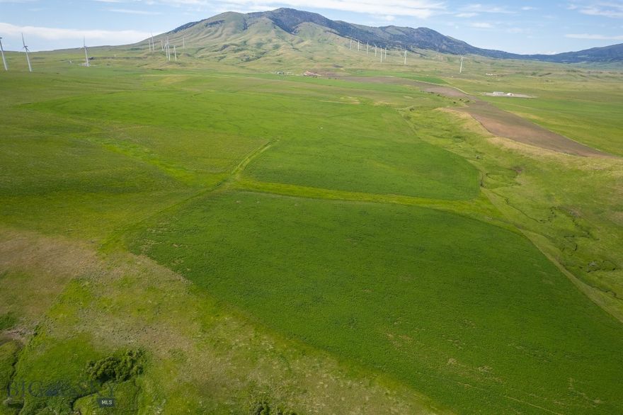 Highwood Mountain Cattle Ranch is positioned along the Highwood Mountain front in central Montana. Covering 3,630 total acres, the ranch offers a strong combination of productive grazing land, practical infrastructure, and direct access to public lands—making it well-suited for both a production-focused operator and a buyer who values recreation and long-term land stewardship. The terrain transitions from rolling native grasslands to timbered foothills, providing diverse grazing environments and natural protection throughout the seasons. This variation supports healthy livestock movement, pasture rotation, and year-round usability. Water is well-distributed across the ranch, supporting both cattle and wildlife. Improvements have been developed with long-term function in mind. A well-established network of internal roads and trails provides reliable access to all major pastures and infrastructure. Cattle handling facilities are efficient and thoughtfully maintained, built to reduce stress and improve flow. Outbuildings serve a range of operational needs, from equipment storage to feed management, and are positioned for convenience without disrupting the landscape.

The ranch borders the Lewis and Clark National Forest, providing direct access to expansive public ground. This boundary adds both privacy and recreational depth, with consistent elk and mule deer movement through the property. For those who value hunting, or simply quiet access to the backcountry, this property is ideal. Land management practices reflect a commitment to long-term viability. Grazing has been handled responsibly, with a focus on maintaining soil health, supporting riparian zones, and encouraging the regrowth of native grasses. The elevation and location provide favorable growing conditions and help buffer extreme weather. Highwood Mountain Cattle Ranch represents a rare opportunity to acquire a proven, well-balanced ranch in a tightly held region of Montana. It offers scale, functionality, and recreational upside—with the infrastructure and land quality to support continued success.

Ranch can be offered without the wind power lease for 11,250,000