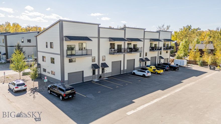 Welcome to the highly desirable Live/Work Community, where flexibility and opportunity come together! This FULLY FURNISHED dynamic property offers endless possibilities—whether you’re looking to launch or expand a business, create a multi-functional workspace, enjoy it as a stylish primary residence, or leverage it as a lucrative rental investment. With covenants that allow for short-term rentals, the potential here is truly unmatched. Inside, you’ll find modern finishes throughout, including quartz countertops, luxury vinyl plank flooring, stainless steel appliances, and a covered third-floor balcony perfect for fresh air breaks or evening relaxation. The layout is designed for both functionality and versatility:
Level 1: Finished commercial space featuring 3-phase electric, a 12’ x 12’ roll-up door, large heated area, and a ¾ bath. This space can easily serve as a business storefront, studio, shop, or even a 4-car garage.
Level 2: Two spacious bedrooms (or private offices), plus a flexible living room/gathering area.
Level 3: A full 2-bedroom, 2-bath apartment with a stylish kitchen and open living area—ideal as a private residence or additional rental income.
Perfectly situated in Four Corners, you’ll have quick and easy access to Bozeman, Big Sky, and Belgrade, making this an ideal hub for both business and lifestyle. Whether you’re an entrepreneur, investor, or simply looking for a unique live/work setup, this property delivers the versatility, quality, and location you’ve been waiting for!