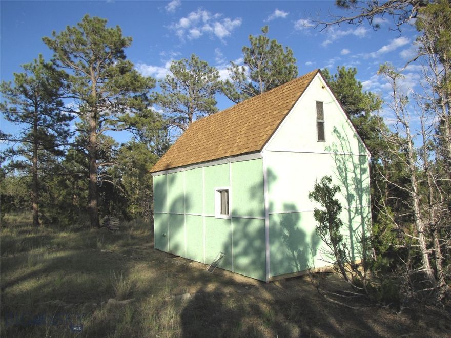 Are you looking for a wooded escape where you can hear the wind blow through the pine trees?  This end of the road property has a small, dry, off-grid 200 sq. foot cabin on it that makes this a great get away site. Being surrounded by Ponderosa pines gives you the feeling of being remote and private, a perfect place to listen to the quiet among a forest of trees with few neighbors. Year-round access is possible with a 4X4, but will require some snow plowing and some road maintenance to deal with mud at times. It is about 10-15 minutes from Roundup and about an hour drive to Billings. Wild turkeys, mule deer, whitetails, bear and elk live in this area, which can make for excellent hunting or just wildlife viewing. Thousands of acres of public land (BLM & State land) are just a mile to the north and west, as well as Lake Mason National Wildlife Refuge about 5 miles further to the north. You are also only 35 miles southeast of access into the National Forest in the little Snowy Mountains where you will also find lots of elk, deer and other wildlife.  Cabin is about 400 to 600 feet from power, it does not have a septic nor any well.  It does have a propane stove for heat, a sleeping loft, some furnishings and is partially insulated. The owner is willing to finance with 20% down.  No known covenants and no zoning. It is approximately 7 miles from Roundup; first 4 miles is well maintained county road, while the last 3 miles is on private roads that have limited maintenance.