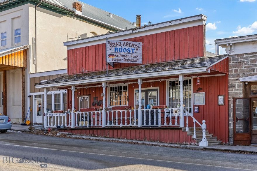 Own a true piece of Montana history in the heart of legendary Virginia City. Built in 1864 as a furniture store with a lumber yard once operating to the east, this remarkable property has stood at the center of town life for over 160 years. During Prohibition, it even operated as a bootleg saloon (speakeasy) out the back, adding another colorful chapter to its storied past. Today, this 3,320± sq ft landmark stands as the largest capacity privately owned restaurant in Virginia City and is being offered for sale with both the business and the building included.
Currently operating as a successful German restaurant for the past seven years, the space blends Old World charm with authentic Western character. Inside, you’ll find three stunning historic bar backs dating from the 1890s, 1920s, and 1940s, each one a centerpiece and conversation starter. Over the decades, thoughtful upgrades and additions have enhanced the property while preserving its historic integrity. The expansive 90-foot commercial kitchen provides exceptional capacity for high-volume dining, catering, or special events. Propane heat services the building. Upstairs, a recently renovated 600± sq ft apartment offers flexibility for owner occupancy, staff housing, or additional rental income. Virginia City, a National Historic Landmark District, draws visitors from around the world with its preserved 1860s frontier architecture, rich gold rush history, museums, live theater, and year-round events. The town sits just minutes from Ennis, renowned for blue-ribbon fly fishing on the Madison River and approximately one hour from Bozeman, offering access to Yellowstone International Airport, Montana State University, and a thriving commercial hub. Surrounded by endless recreation including fly fishing, big game hunting, hiking, horseback riding, ATV trails, and winter sports, this property is positioned to capture strong seasonal tourism and destination dining traffic. With its size, layout, and prime Main Street location, this versatile building lends itself to a variety of uses beyond a restaurant including event venue, brewery, tasting room, music hall, retail mercantile, boutique hospitality concept, or mixed-use investment opportunity. The scale, history, and presence of this property are unmatched in Virginia City. A rare opportunity to own a thriving business and an irreplaceable piece of Montana’s Old West legacy.
