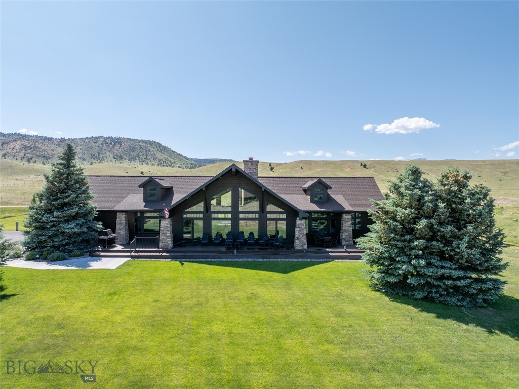 Modern elegance meets Montana living in this completely updated 3,008 sq ft custom home, situated on 4.14 acres, offering refined design and exceptional craftsmanship throughout. Hickory hardwood floors flow through the main living areas, where a floor-to-ceiling double-sided wood-burning fireplace anchors the open layout. This central feature connects seamlessly to a cozy adjacent TV room—perfect for quiet evenings or casual gatherings.
The chef’s kitchen is sleek, functional, and designed to impress with Thermador appliances, a built-in wine fridge, and a clean palette of stainless steel and white finishes. Ideal for entertaining or enjoying a quiet night at home.
Four spacious bedrooms and 2.5 bathrooms provide comfort and flexibility. The primary suite offers a tranquil retreat with expansive views and upscale finishes. Three guest bedrooms are positioned at the opposite end of the home, providing optimal privacy for family and visitors.
Large windows throughout frame panoramic views of the Madison Range, bringing in natural light and emphasizing the home’s seamless indoor-outdoor connection. A dedicated office with custom built-ins and fiber optic internet, large closets throughout home and a finished garage with cabinetry and epoxy floors enhance organization.
This property is fully equipped for comfort and efficiency with a whole-house backup generator, blacktop front driveway, RV parking, and an irrigated yard with mature landscaping.
Outdoors, enjoy golf cart access to Valley Garden Golf Course or explore downtown Ennis by foot or bike via the nearby pedestrian trail. Ennis offers a vibrant Main Street filled with boutiques, restaurants, and galleries, along with a public airstrip for private aircraft and Bozeman and Yellowstone National Park are just an hour away.
10 Wood Duck combines luxury, comfort, and convenience in a truly breathtaking setting. A rare opportunity to own a fully furnished, turnkey home in one of Montana’s most scenic locations. Call today to learn more about the custom features that set this home apart.