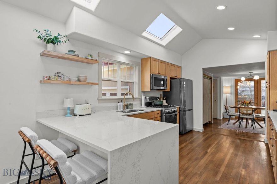 A timeless Southside Bozeman bungalow, thoughtfully reimagined for modern living, set directly across from the beloved Southside Park. This rare downtown residence pairs the architectural character of a 1940s home with contemporary updates and exceptional flexibility—just minutes from Montana State University and the heart of Bozeman. 

Spanning approximately 2,430 square feet, this thoughtfully updated home can live comfortably as a 4-bedroom + office, 2-bath single-family residence, or be utilized as a main-level home with a separate lower-level apartment. The main level features two bedrooms, a light-filled living room, kitchen, laundry, and a versatile office or dining space—highlighted by vaulted ceilings, skylights, original hardwood floors, and refined finishes that honor the home’s era while embracing modern style.

The lower-level apartment offers a private exterior entrance and includes two bedrooms, a kitchen, bathroom, and living area—ideal for flexible living arrangements or additional income potential. This versatility sets the property apart in the downtown market.

Additional highlights include an attached one-car garage (a true rarity in this location), air conditioning for year-round comfort, elegant plaster details, abundant natural light, and thoughtful renovations throughout. Enjoy immediate access to Southside Park’s tennis courts, playground, winter ice skating, and the unbeatable access to downtown dining, shopping, and recreation. Offered fully furnished for turn-key use.

A distinctive downtown Bozeman home offering location, flexibility, and timeless appeal—this is Southside living at its best.