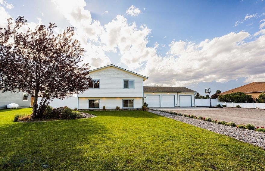 Located on just under half an acre, this meticulously maintained split level home offers a perfect blend of comfort  and convenience. The main floor spans  1536 sq.ft. featuring a spacious master suite,  3/4 bath, two guest bedrooms and a full bath. An updated kitchen is a chefs choice boasting granite countertops, rich walnut cabinets, stainless steel appliances and vaulted ceiling with abundant windows filling the space with natural light. A tasteful mix of tile, carpet and laminate flooring adds warmth and style.  The full finished basement, covering 1,380 sq.ft. includes another master suite, full bath with walk in closet.  A versatile guest bedroom/family room/game room, full bath with laundry area, a storage room,  complete the basement area  with large windows and 9 ft. ceilings.  The attached three car garage (1184 sq.ft.) is fully finished, heated, complete with a dog door and water access- perfect for year around comfort plus lots of storage.  Step outside to enjoy the beautifully landscaped yard, featuring raised beds, vinyl privacy fence, and underground sprinkler system in the front yard.  Relax on the covered back deck and take in the stunning views of multiple mountain ranges.  All just three miles from town, this home combines tranquility with accessibility.