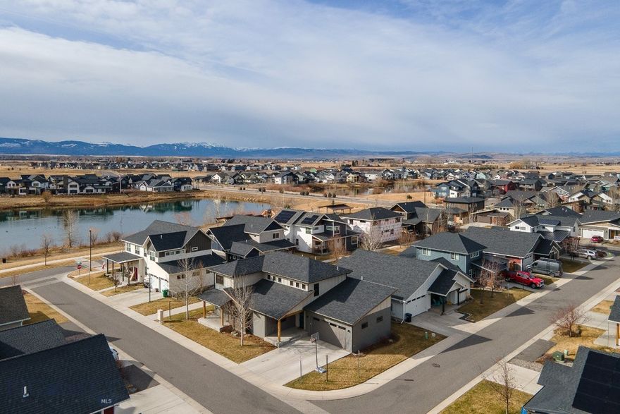 Set against breathtaking views of the lake and Mount Blackmore, this exceptional five-bedroom, three-bath residence offers an elevated Montana lifestyle in one of Bozeman’s most sought-after west side communities. Expansive windows frame the surrounding landscape, filling the home with natural light while capturing panoramic mountain and lake views from the main living areas.

Thoughtfully designed for comfort and flexibility, the main level features a spacious primary suite along with an additional bedroom and full bath—ideal for guests, a home office, or convenient single-level living. Generous gathering spaces create an easy flow for entertaining while still offering warmth and everyday livability.

Located in the charming Lakes at Valley West, known for its intimate streetscapes, walkable design, and low-maintenance homesites inspired by classic European neighborhoods, residents enjoy miles of trails, nearby parks, and year-round recreation. Spend summer days paddleboarding or swimming on the lake, then enjoy winter ice skating and fishing just steps from home. The lakes are stocked each spring, creating a unique local amenity right in the neighborhood.

Perfectly positioned just minutes from downtown Bozeman and the Marketplace, this home offers the rare combination of scenic beauty, convenience, and lock-and-leave ease. Additional upgrades include a Kinetico water softener and whole-home dechlorination system.