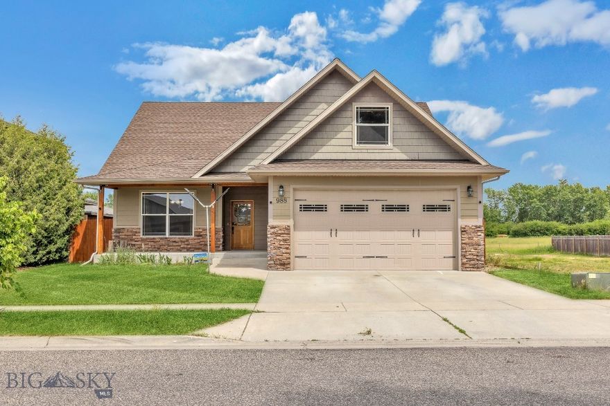 Welcome to 988 Meagher Ave, a warm and versatile 4-bedroom home in Bozeman’s Oak Springs neighborhood. With over 2,200 square feet, there’s plenty of space to spread out, including a bonus room that could be used as a dining room, home office, or cozy den. The vaulted ceiling and gas fireplace with stone surround make the living area feel open and welcoming.

Upstairs, a large bedroom or flex space offers even more possibilities. The backyard is fully fenced with tall privacy fencing for seclusion and security, and it backs to a wide-open green space that adds a peaceful, private feel. A built-in speaker system runs throughout the home and deck for easy entertaining, and there's an attached garage with parking for three more vehicles in the driveway, plus street parking.

Located mere steps from the 0.6-mile Oak Springs Park loop, the home connects directly to the 4-mile Westside Trail, offering seamless access to Bozeman Pond, a local favorite for dog walks, relaxation, and recreation. Part of Bozeman’s extensive 52-mile trail network, this location is ideal for outdoor lovers while staying close to schools, shopping, and everything in between.