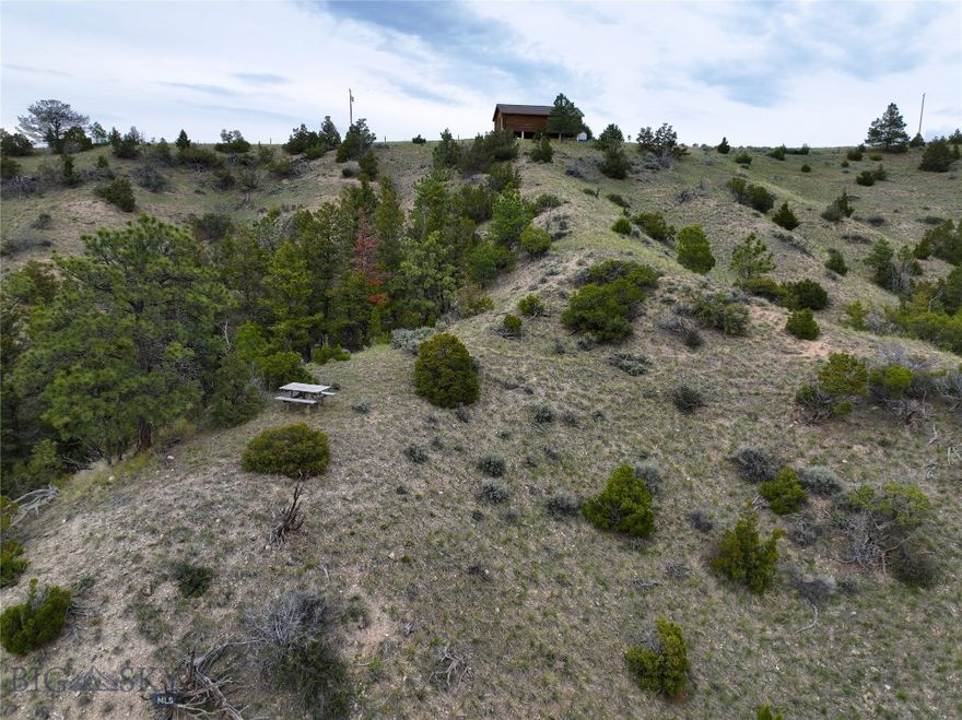 This property has a cozy cabin overlooking the stunning Canyon Ferry Reservoir—Montana’s third largest lake, offering over 76 miles of scenic shoreline. The charming retreat features power and a permitted septic system, making it ideal for recreational use or as a comfortable guest cabin. The cabin utilizes a water catchment system, and comes furnished. With additional buildable areas on the property, new owners have the option to construct a dream home while keeping the cabin as a bonus space. Perfectly situated for outdoor enthusiasts, the property is just minutes from National Forest access, waterfowl sanctuary (WMA Area), and world-class fishing and boating opportunities on Canyon Ferry. Whether you’re seeking weekend getaways, a base for year-round adventure, or a peaceful place to unwind, this property offers it all.