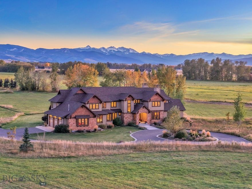Just fifteen minutes from downtown Bozeman lies a property that feels worlds away. This rare 40+ acre legacy estate is where mountain views, open sky, and Hyalite Creek-fed waters converge into something timeless. This is not just a home; it is a place meant to be passed down; a Montana story still being written.

Designed by Claire W. Danes, one of Montana’s most respected architects known for his mastery of natural light and harmony with the surrounding landscape, the residence was crafted to capture the soul of the land itself. The home’s grand, south-facing orientation invites sunlight to spill across the interiors, framing the Spanish Peaks, the Gallatin Range, and the Bridger Mountains in every window. Each view becomes a living painting that transforms with the seasons. The sound of moving water creates the soundtrack to your mornings.

The property offers space to expand into a horse estate with a barn or stables, to create trails that wind along the creek, or to build a sanctuary for future generations.

Inside, every detail speaks to craftsmanship and comfort. The chef’s kitchen is both functional and beautiful, featuring double ovens, dual refrigerators, twin dishwashers, and an oversized island designed for gathering. The vaulted living room opens to sweeping mountain vistas and a hand-laid stone fireplace that anchors the home with warmth and permanence.

The primary suite offers a retreat for the senses. Its spa-inspired bathroom and tranquil views create a haven of rest. A dedicated wellness room and outdoor patio invite movement, meditation, and sunrise yoga sessions. Upstairs, five bedrooms, three bathrooms, and flexible spaces for guests, creativity, or play ensure there is room for everyone.

Beyond the main residence sits a three-bedroom guest home, perfectly positioned with panoramic views of the Bridger Mountains. It is ideal for extended family, visiting friends, or a high-end rental opportunity.

Outside, Montana living unfolds effortlessly. Enjoy a hot tub beneath the stars, a firepit for long evening conversations, and Middle Creek Ditch bordering the southern edge, carrying water from Hyalite Creek from June through November. The land invites both solitude and gathering, recreation and rest.

This is a property meant to be lived in deeply, where mornings begin with coffee by the creek and evenings end under the constellations that once guided Montana’s earliest settlers. It is a home designed for generations.