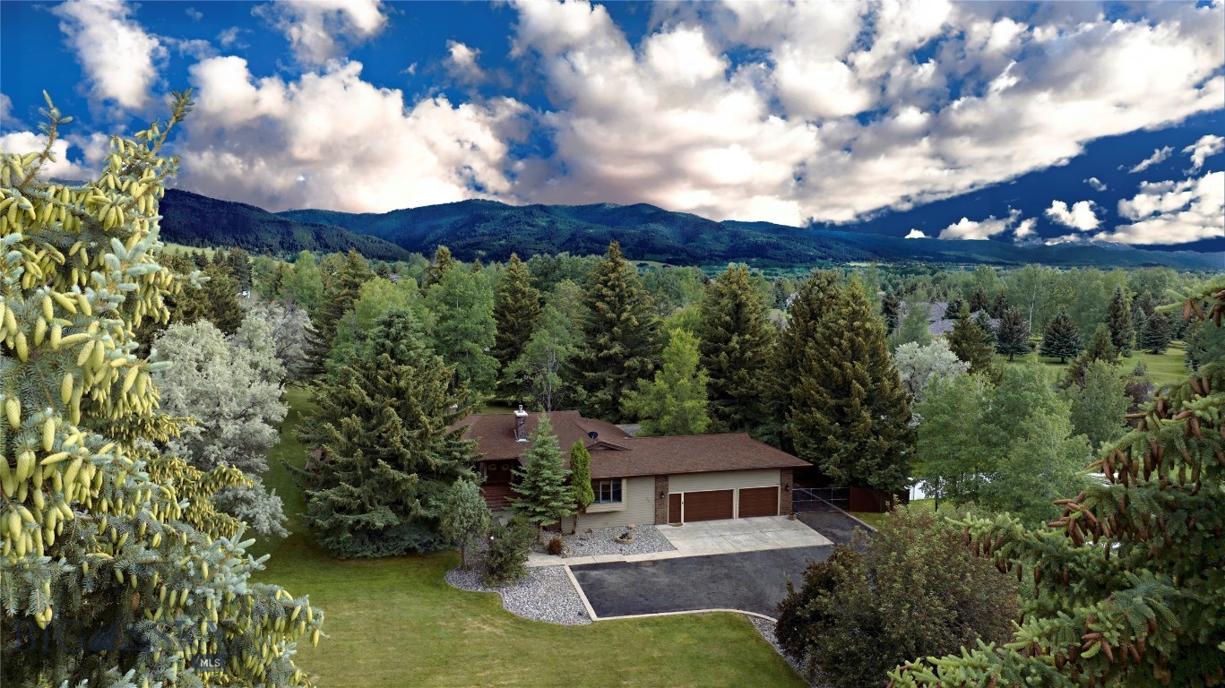 Welcome to the Wagon Boss. This is an extraordinary, limited opportunity to own a property in Bozeman without any HOA fees in an extremely exclusive neighborhood. This two wing 3084+/- sq ft single level residence is situated on 2.064+/- acres in a park-like setting with immense pine trees. The property is capable of building an additional ADU or another single-family home on the back lot with its own separate entrance and exit onto Sourdough Rd. The backyard encompasses 1000+/- sq ft of deck space for entertaining, hot tubbing, or setting back and watching the deer pass through the property. The interior of the home starts with a formal entry way leading to a magnificent great room flanked by a respectable dining room. The west wing consists of the kitchen, wet bar, second dining area, living room with fireplace, laundry room, garage entrance, and junior master suite with full bathroom. The east wing includes two guest bedrooms, with a shared Jack and Jill ¾ bath, an enormous master suite with walk-in shower, jacuzzi tub, master closet, and French doors leading to the vast outdoor deck. The three-car garage has considerable over car storage. The formal driveway leads to six car spaces of ample parking and an additional gated RV space on the side of the garage. Come and see this rare opportunity in Bozeman before it is gone.