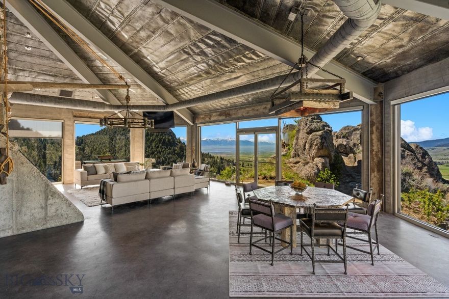 Perched majestically amidst stunning granite rockscapes and perfectly situated backing thousands of acres of State and BLM land, this mountain
retreat has been masterfully engineered to capture the awe-inspiring beauty and rugged landscape Montana dreams are made of. Seamlessly
integrated into the natural environment and inspired by Montana's rich mining heritage, this contemporary marvel blends reclaimed wood accents,
natural cut stone, and rolled tin ceilings to create a one-of-a-kind piece of liveable art. No detail has been overlooked in the spacious interior,
equipped with a chef's kitchen boasting Viking, Subzero, and Asko appliances, a full coffee station, expansive prep areas, and a walk-in pantry. The
open concept living/dining area has been expertly engineered to capture the surrounding vistas spanning from Lone Mountain to Ward Peak,
extending to the Centennial Mountain Range, and overlooking sweeping acreage of rural charm. The main level also features the commanding
master suite, encased in floor to ceiling windows and featuring an opulent master bath and walk-in closet. Take the Otis elevator to the lower level,
which features two additional en-suite bedrooms each with their own private patio, fully equipped theater room, walk-in safe, office/gym room with
private patio and ½ bath, as well as underground access to the expansive 5-bay garage, complete with both heating and cooling, central vacuum,
epoxy floors, and Hotsy Power Wash system. Above the garage, a fully equipped guest apartment boasts two en-suite bedrooms, a bonus/office
space, full gourmet kitchen, and spacious living area with fireplace. This meticulously crafted oasis is thoughtfully outfitted with full home Crestron
automation, radiant in-floor heating, central A/C, Sonos surround sound, security system, and more, all controllable from the palm of your hand.
Embrace equestrian pursuits with the Ameristall 3-stall barn plus tack and storage room and 5 acres of fenced pasture, set within the sprawling 192+
acre estate boasting diverse terrain, private canyon, miles of hiking, biking, or horseback trails, and abundant wildlife.Just beyond the property lines
lies the charming community of North Meadow Creek, and a quick drive into the idyllic town of Ennis provides access to restaurants, grocery
shopping, fly fishing outfitters, and additional recreational opportunities. Experience the pinnacle of Montana living in this once in a lifetime custom
retreat.