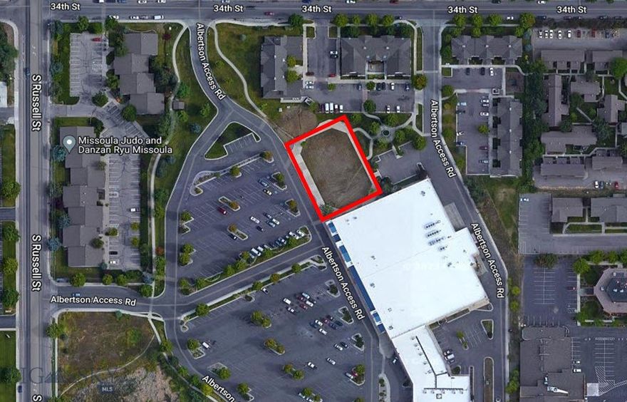 Unique opportunity to acquire a prime commercial development parcel within the established and highly visible Russell Square Shopping Center. This rare parcel is ideally situated in a vibrant commercial corridor surrounded by dense residential neighborhoods, schools, and other service-oriented businesses. The property offers exceptional potential for neighborhood-serving uses such as daycare, financial institutions, eating establishments, medical, or professional services. Please note that certain commercial and multi-family uses are restricted under the site’s CC&R's—interested parties are encouraged to review these documents. All uses are subject to final approval by Albertson’s Corporate. With limited development land available in this sought-after area, this site represents a standout opportunity for businesses looking to serve the growing South Missoula community.