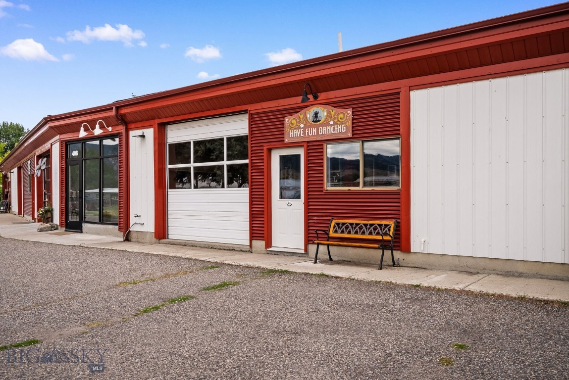 Step into your next commercial opportunity! Conveniently located in vibrant northeast Bozeman, this commercial condo space provides an operating base for a variety of business use types. Most recently it was home to a popular dance studio and is move in ready for a new dance or fitness focused enterprise. The interior open space comes equipped with specialty features including a double sprung floating hardwood floor, acoustic wall panels, and wall of mirrors - all of which are attached with screws and can be dismantled and removed with ease. The flexible space could be configured to meet a variety of uses permitted with M-1 zoning. Features include a manually operated overhead door, ceiling fans, forced air natural gas heater with thermostat, ADA restroom, ramp to dance floor, natural light from front and back windows, storage closet, kitchenette with sink, under counter refrigerator, and microwave. Shared parking outside the front door with adjacent city street parking. Convenient to many of Bozeman's favorite local destination spots. Ready for your personal studio space? Need more space to expand or launch your next venture? Be sure to check this out now!