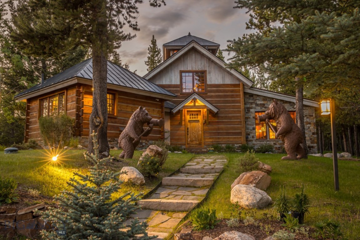Between Bozeman and Yellowstone National Park, this extraordinary 20-acre property offers unmatched privacy and sweeping panoramic views, just ten minutes from both Big Sky Resort and Town Center. A sunlit meadow framed by mature spruce and aspen trees serves as the future main house site, capturing breathtaking vistas of Lone Mountain, the Spanish Peaks, the Yellowstone Club, and Buck Ridge. A 2,000-square-foot guest house crowns a landscaped knoll overlooking the meadow. Designed with mountain character and artisan craftsmanship, it features soaring ceilings, a dramatic stone fireplace, a hand-crimped copper roof by renowned metalworker Mike Winters, and a whimsical glass-floor cupola. Luxurious touches include radiant heat, Lutron lighting, a steam shower, and a full washer and dryer. Above the oversized two-car garage, the caretaker’s quarters offer additional guest accommodations with warm barnwood interiors, wide-plank Douglas fir floors, and a river rock shower with a cracked marble floor. The 20-acre grounds are beautifully manicured, with rolling lawns, rock gardens, and nearly a mile of private hiking and fitness trails. In winter, the coveted Boomerang Nordic trail—part of Lone Mountain Ranch’s nationally acclaimed network—winds discreetly through the property, offering direct access to world-class cross-country skiing. Amenities include a six-person hot tub, lantern-lit driveway, Starlink internet, ADT security with cameras, and an extensive irrigation system. This is a rare Big Sky legacy property, offering the perfect blend of privacy, luxury, and year-round recreation.