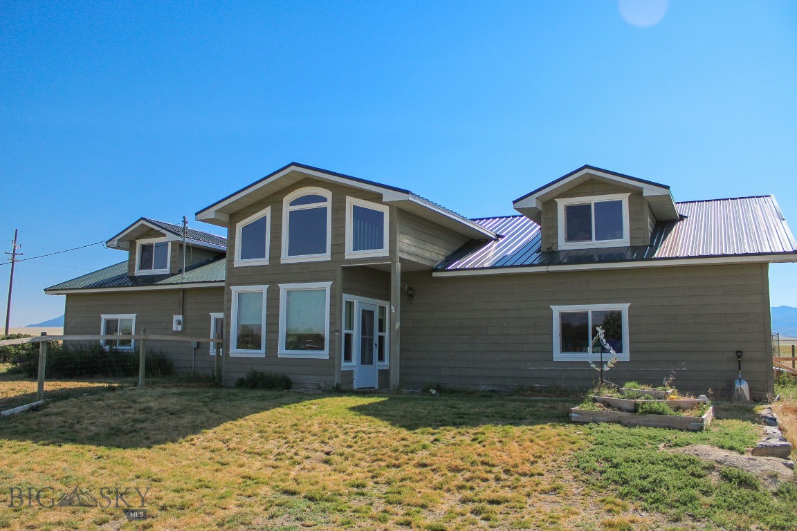 Custom Home with Expansive Shop on 1.3 Acres – No Covenants! A rare opportunity in the heart of the Ruby Valley, this stunning 3,450 sq ft custom home offers breathtaking views of the Tobacco Root Mountains and the freedom to live your lifestyle - unrestricted! Through the front door, you step into the grand tiled foyer with soaring ceilings and double-height windows that flood the space with natural light. Bonus: this home boasts brand new windows throughout! The open-concept kitchen features an oversized island and seamless flow into the living room, complete with a cozy wood-burning fireplace—perfect for entertaining or quiet evenings. Located between Twin Bridges and Sheridan, enjoy the charm of small-town living with easy access to shopping, schools, and entertainment. The main level includes 2 spacious bedrooms, 1.5 bathrooms, updated kitchen, mudroom with locker-style cubbies, laundry room, large dedicated office, & an attached 320 sq ft single-car garage. Upstairs, the private primary suite boasts two walk-in closets and an east-facing balcony ideal for sunrise coffee. A generous landing offers space for a sitting area, while the oversized 2nd bedroom/bonus room with dormers provides endless possibilities. Outside, the 1.3-acre lot includes a fenced yard for pets, space for a greenhouse, chicken coop, or 4-H projects. Finally, the detached 1,280 sq ft insulated garage/shop with enclosed workspace offers relief from those snowy Montana winters and a separate area for all your projects! Enjoy panoramic mountain and valley views in one of Southwest Montana’s most picturesque settings. Call today and come see for yourself!! Note: Property lies within the Twin Bridges Airport Affected Area.