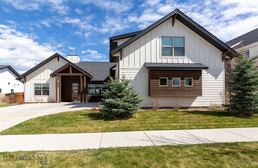 Designed and constructed by Black Diamond Development, this home is a refined and well-finished example of the modern farmhouse aesthetic designed to capture strong Bridger Mountain and park views. The home is characterized by its "mostly main floor" configuration, with more than 3/4 of the living space situated on the ground level. This layout provides the convenience of single-story living while maintaining a distinct, separate upper-level suite with a full bathroom, a separate mini-split system, and easy access via interior stairs. The living room, kitchen window, primary bedroom and one of two additional main-floor bedrooms face the Bridger Mountains. A custom-built mantle serves as a vertical focal point, extending from the fireplace to the ceiling line. The kitchen is designed for high-capacity culinary use, anchored by a 64-inch (wide) professional-grade refrigerator and freezer. Cabinetry extends to the ceiling and is paired with white quartz countertops, a tile backsplash, and LED under-cabinet lighting. A custom-built hood provides a clean visual finish above the range. The oversized center island includes the sink and has a significant workspace that serves as the transition between the kitchen and the living room and dining area. The primary suite has a free-standing tub, and a trough sink with dual faucets. The primary shower is fully tiled across the walls and the ceiling. The second floor can be used as a bonus room or fourth bedroom with a bathroom and the room uses a separate mini-split system to ensure climate control independent of the main floor. Within the past five years, a whole-house air conditioning system and a humidifier were integrated into the HVAC system. This is a smart home: WiFi-enabled full-house water shut off, garage doors, and sprinklers; smart thermostat; robust Simplisafe security, including: interior and exterior cameras, window and door sensors, glass-break detection, a smart thermostat, a low-temp sensor, and moisture sensors at each interior location with water. The property is very well located within northwest Bozeman. The home is within walking distance of Gallatin High School. It sits just west of the 100-acre regional park. The park contains the 17-acre “Lewis and Bark” dog park that includes a pond with a dock, and the larger park has two additional ponds and a trail that connects to Bozeman's 80+ mile "Main Street to the Mountains" interconnected trail system.