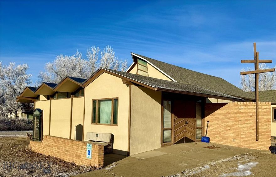 Located just one block from Highway 2, a 3,200-square-foot building that formerly functioned as a church is now available for purchase, offering limitless creative possibilities. This brick structure is equipped with a chair lift for wheelchair accessibility to the basement, along with three offices or workrooms, a sanctuary, and a spacious fellowship hall complete with a full kitchen that has a separate exterior entrance. Additionally, the property includes three bathrooms: one in the basement and separate facilities for men and women on the upper level. Ample parking is also available on-site.