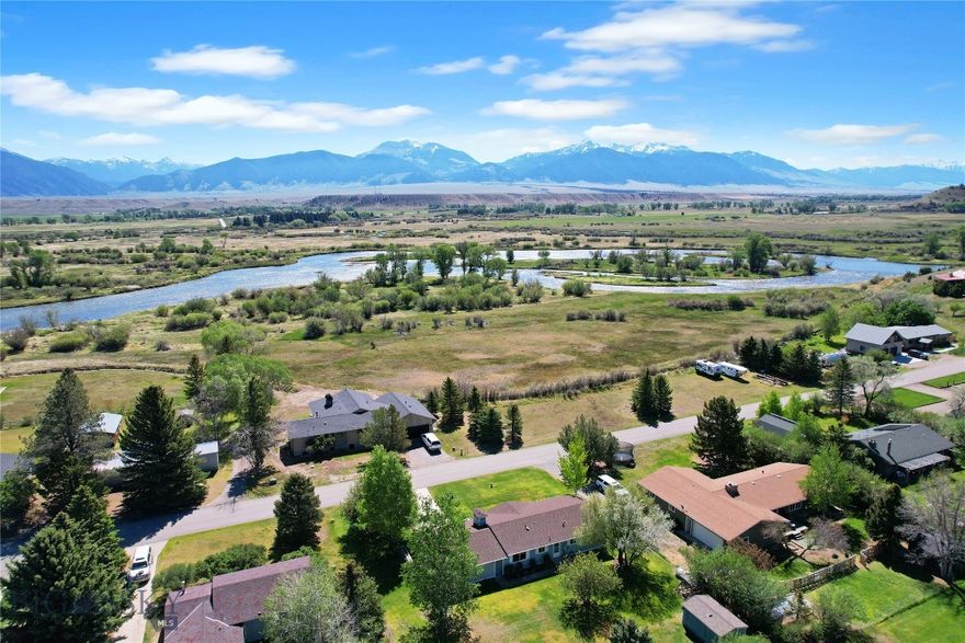 Incredible location in lower Ennis as this home is only a stone's throw from the Madison River, only a few blocks from downtown, and less than an hour to Bozeman's International Airport and Yellowstone National Park.  The "upper bedroom - bath" ensuite is large, roomy, has a walk-in closet and is located in such a way as to give the "master" of the house increased privacy.  There is a second bedroom that is large enough to be your guest room as well as your office.  Fiber Optics is already in the home that creates a great option for a live-work unit.  There are decks off both the back and front (east & west sides of the house) and the back yard of this 1/3+ acre lot is chain link fenced - ready for your dogs.  There is an attached one car garage (with additional storage in a lean to) as well as a utility shed.  The Madison Valley is home to elk, deer, mountain goats, moose, big horn sheep, and a million +/- trout.  Big Sky snow skiing is just over the mountain, snowmobiling is south of Ennis, hiking - biking - horseback riding trails are found everywhere.  In Montana you don't just buy a property - you purchase a new lifestyle!!