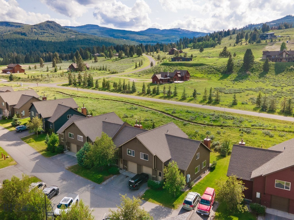 Just one mile from the heart of Big Sky, this end-unit chalet at 417 Firelight Drive offers the perfect balance of convenience, privacy, and outdoor adventure. With its prime location bordering open space and the added privacy and natural light of an end-unit, this home lives like a single-family residence. Inside, you’ll find three ensuite bedrooms, a versatile loft, and a one-car garage — ideal for full-time living or a mountain getaway. This thoughtfully designed 3-bedroom, 3-bathroom condo provides generous space for both family life and hosting guests. The open-concept layout features a cozy fireplace, soaring ceilings, and expansive windows that flood the interior with natural light while framing the breathtaking Montana landscape — perfect for gathering with friends or simply unwinding in comfort.