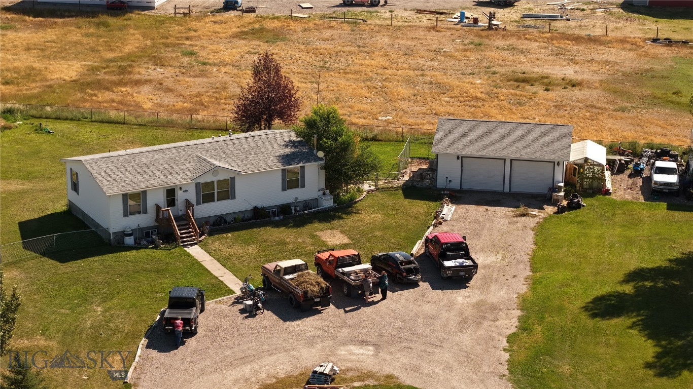With an out of town feel and in town ease of services, the best of both worlds combine with this beautiful 2003 manufactured home featuring a full basement and room for everyone. A private pond stocked with fish is a short 100 yard walk from the front door that will provide hours of swimming, fishing and entertainment for all. Entertain guests downstairs at the built in wet bar. A detached two car garage was constructed in 2018 and provides warm vehicles on a frosty winter morning. The garage also provides ample storage for tools, toys and lawn equipment. A roof and siding update were completed in 2020 and are welcome additions to this wonderful piece of Montana. Underground sprinklers, will keep the lawn and the mature landscaping looking green and lush throughout the warm summer months. Don't let this unique home slip away, call today to schedule a showing!