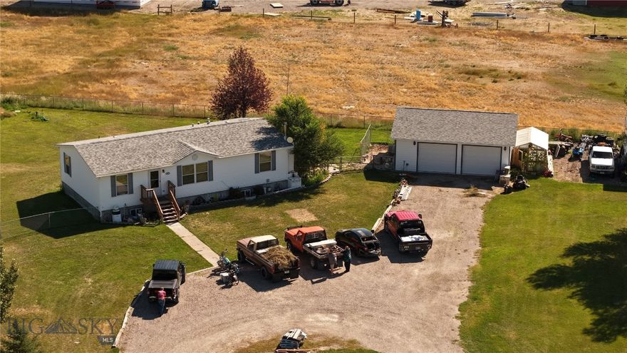 With an out of town feel and in town ease of services, the best of both worlds combine with this beautiful 2003 manufactured home featuring a full basement and room for everyone.  A private pond stocked with fish is a short 100 yard walk from the front door that will provide hours of swimming, fishing and entertainment for all.  Entertain guests downstairs at the built in wet bar.  A detached two car garage was constructed in 2018 and provides warm vehicles on a frosty winter morning.  The garage also provides ample storage for tools, toys and lawn equipment.  A roof and siding update were completed in 2020 and are welcome additions to this wonderful piece of Montana.  Underground sprinklers, will keep the lawn and the mature landscaping looking green and lush throughout the warm summer months.  Don't let this unique home slip away, call today to schedule a showing!