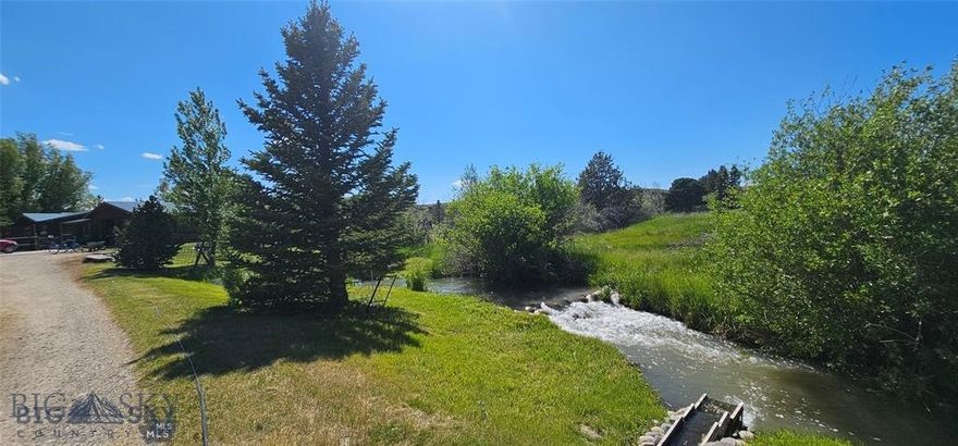 Bear Creek Beauty – Creek, Ponds, Views, and Privacy! Don’t miss this exceptional property just minutes from downtown Ennis! Nestled on 9 scenic acres, this unique 2,552sq. ft. 4 bedroom, 2 bath home offers the perfect blend of natural beauty, privacy, accompanied by the peaceful sounds of the creek all with breathtaking mountain views. Bear Creek runs through the entire property, bringing movement and life to the landscape, complemented by two peaceful ponds enhance the natural charm. Mature landscaping, surrounded by mature trees and abundant wildlife. Inside, the open floor plan features a spacious kitchen, a dining area that opens onto the back deck—ideal for barbecues, entertaining, or simply soaking in the scenery. Enjoy a cozy living room with large view windows, a generous family room with a fireplace, two primary suites, plus two additional bedrooms. The grounds are a true standout, featuring mature landscaping and a mix of towering trees, including five spruce trees approximately 100 feet tall and 26 more ranging from 20 to 25 feet. A massive cottonwood, three additional cottonwoods between 30 and 40 feet tall, three aspen trees, and five mature willows provide beautiful shade and a sense of serenity in the backyard. For those who value privacy and protected views, the property backs up to the Longhorn Ranch, which is under a conservation easement—ensuring that the surrounding land remains undeveloped and preserved for generations to come. This home is a rare find in a highly desirable location. Serenity meets accessibility—don't let this one slip away!