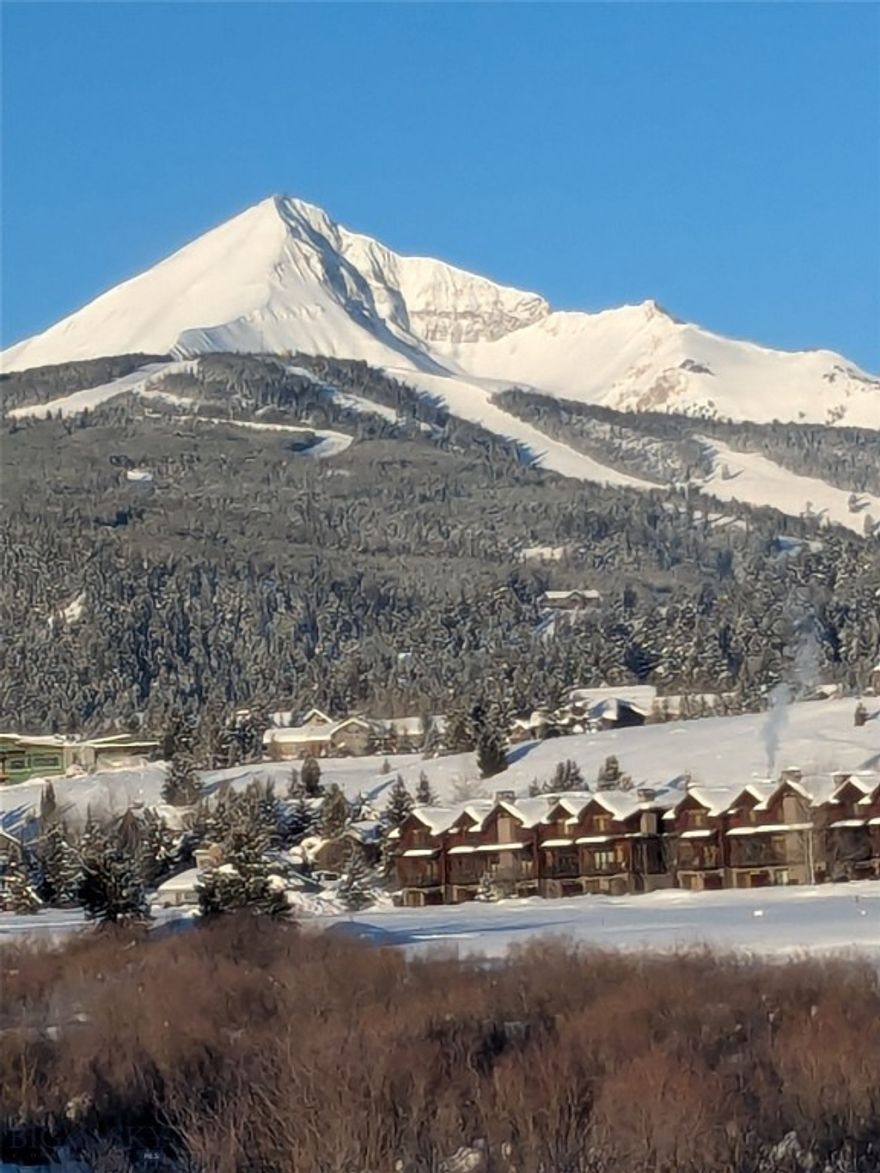 Seller is the 2nd owner since this unit was built in the early 1970's.  Offering spacious views overlooking Silver Bow Pond and Big Sky (public)Golf Course with unobstructed vistas of Lone Peak elevation 11,166' in the Madison Range! One level living with views from every room. Silver Bow Condominiums sit on acres of open space and allow for spacious living within the complex.  A private Homeowners Recreation Building houses the shared Hot Tub, Dry Sauna, Laundry facilities, and NEW outdoor pool. 
Silver Bow #46 has wood composite floors throughout the living space. 3 Bedrooms are carpeted. Bathroom floors tiled. The entire unit has new paint.  Quartz countertops in kitchen and both baths. The layout allows privacy in bedrooms which are located 'down the hall' from the central living area. The open concept Great room includes comfortable seating with cozy wood fireplace, dining area, and upgraded kitchen.  Outdoor dining on enlarged deck, ALL windows face Lone Peak and west facing deck access door is from the Living Room.  SOLD FULLY FURNISHED.  Walk right in & look at the views and ENJOY!!