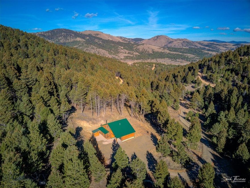 No Covenants, No HOA! Charming Cedar Log Home on 20+ Acres with Spectacular Views – Jefferson City, Montana. Welcome to your dream Montana retreat! Nestled on 20.671 beautifully wooded acres, this stunning 1,440 sq ft cedar log home blends rustic charm with modern comforts. Located just minutes from Jefferson City with easy year-round access, this property offers the perfect balance of privacy, natural beauty, and convenience. Step inside to find a warm, inviting interior featuring exposed wood and log beams, recessed lighting, and thoughtful wood accents throughout. The main living space boasts a cozy yet open layout with a spacious loft and an additional living area, perfect for guests, a home office, or a hobby room. The home offers 2 bedrooms and 1.5 bathrooms, ideal for full-time living or a weekend getaway. Step out onto the covered front porch to take in panoramic mountain and forest views or enjoy peaceful evenings around the fire pit. There’s covered firewood storage nearby to keep you warm all winter long. For your vehicles and gear, there's a 1-car garage and dedicated RV parking with full hookups—ideal for visiting friends or exploring life on the road. The property also includes a private 22 GPM well, private septic system, and ample room for gardening, hiking, or future expansion. Whether you're looking for a serene full-time residence, a seasonal escape, or a basecamp for all your outdoor adventures, this unique log home delivers.