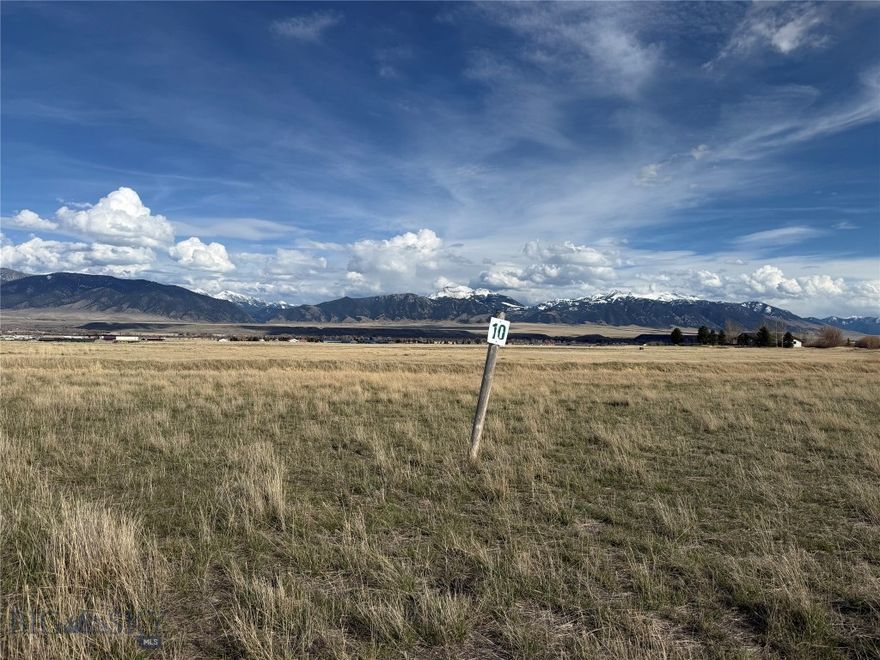 Lot 10 is a great view lot on the upper bench, with views of the valley and 3 mountain ranges!  It has a seasonal irrigation canal running through the property for a great water feature.  There are common area ponds, fed from the irrigation canal which create a beautiful Duck Rookery from April through October.  Just 2 miles NW of Ennis and 1 mile to the Madison Meadows Golf course - ride your golf cart there!  Pintail is a premier neighborhood and one of the best locations in the valley. Close to golf course, tennis courts, pickleball courts, Ennis Lake, numerous fishing access sites along the Madison River, trails into National Forest, historic Virginia City and just 1 1/2 hours to Yellowstone National Park!  Pintail Ridge has strong covenants protect property values.  HOA dues cover road maintenance and common areas - including the ponds and trails.  Enjoy the convenience of being close to town, while living in the country. Beautiful homes in a community that takes pride in their neighborhood.  Lots for sale in Pintail Ridge are hard to come by.  It won't last long.  The lot includes an older test well, which is not in the approved DEQ location for a well for residential use, but it was recently tested and pumps 3 GPM.