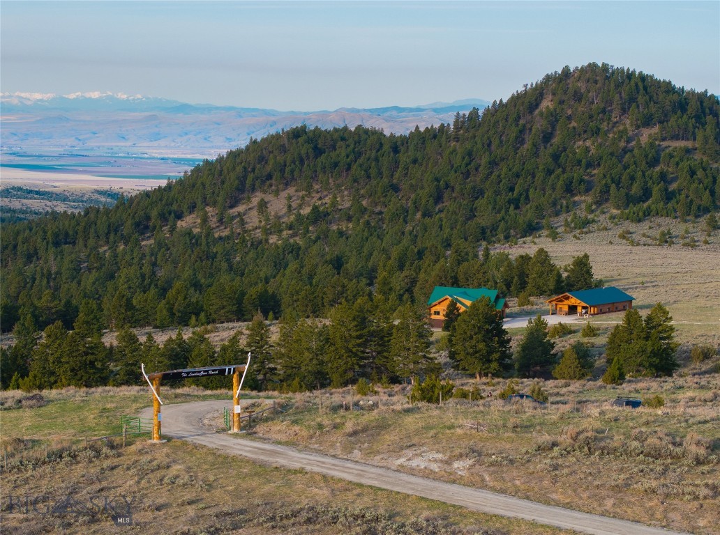 Gear Up for the Ultimate Montana Retreat – Built for Warriors, Hunters, and Hard-Charging Outdoorsmen
Load out from Townsend and make your way around Canyon Ferry Lake, then head up Duck Creek to a rugged custom log home sitting on nearly 85 private acres at the base of the Belt Mountains. This isn't just a home—it's a forward operating base for your Montana lifestyle, which can be powered by the Generac back up power when needed.
Bordering 636 acres of state land, this property is a hunter’s dream in Deer/Elk Hunting District 391. Whether you're tracking elk, the elusive cat or setting up for deer, the opportunities here are endless with BLM and National Forest access close by. The property includes an old landing strip and a rustic skeet range
With Canyon Ferry Lake down the road for trophy Walleye, it is also fit for the avid fisherman to dip a line or run around the 30 mile plus long lake with kids in tow on a tube. Or sail over the lake with one of the local Paraglide outfitters for some real scenery and adventure!
This home is built for those who get things done—the massive logs were flown in and set by the owner himself via helicopter. The main level boasts a commanding primary suite with loft, plus an oversized guest room and loft space. Downstairs is a walk-out level with 2 more bedrooms that can convert into a full 3-bedroom guest apartment—ideal for your crew, family, or fellow servicemen. For added privacy or overflow accommodations, there’s also a separate guest apartment tucked behind the expansive six-car garage.
There's even a dedicated gun safe room for your weapons, reloading gear, and secure storage. Ride directly from your doorstep into the wild. After a long day on the land, cool off in the spring-fed pond, hot tub or relax around the fire with brothers-in-arms.
Whether you’re hosting a hunting party, training weekend, or just getting off-grid, this property is built for resilience, camaraderie, and freedom.