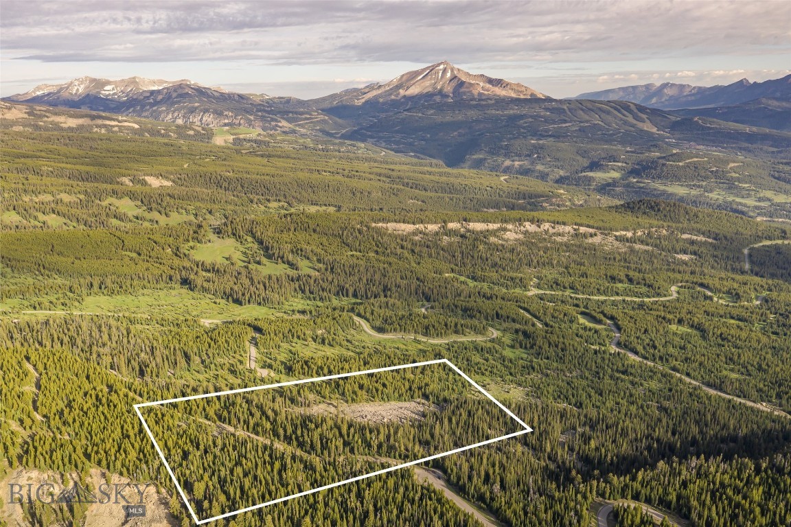 Quite possibly the most breathtaking views in all of Big Sky. This exceptional homesite offers panoramic vistas stretching from Pioneer, Cedar, and Lone Peak to the Spanish Peaks, Gallatin Range, and even into Yellowstone National Park. Perfectly positioned at the end of a quiet cul-de-sac and bordering 160 acres of deeded open space, the property offers unmatched privacy and direct Big EZ HOA access to National Forest trails and recreation. Ideally situated adjacent to the Yellowstone Club and Spanish Peaks Mountain Club, and only 15 minutes to the heart of the Big Sky Town Center, crossing the Westfork of the Gallatin River via a hand hewn timber framed bridge, you drive up a paved road to the most magnificent views in Big Sky!
Located in a gated community, with the option to join the prestigious Spanish Peaks Mountain Club, this is a rare opportunity to secure what may be the most remarkable homesite in all of Big Sky. Whether building your legacy generational retreat or a private mountain sanctuary, you'll enjoy unparalleled views, serenity, and access to world-class amenities.
Well and septic to be installed by buyer. A Ski Social membership is available and must be secured prior to closing.