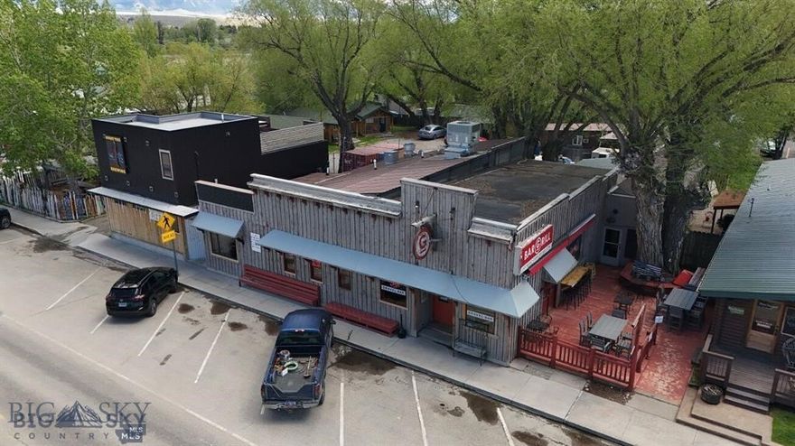 Here’s your chance to own one of Montana’s most iconic bar & restaurants! Located in the heart of downtown Ennis, The Gravel Bar is a beloved local institution that perfectly captures the town’s laid-back, welcoming spirit. Known for its wide selection of craft beers, hearty food, and friendly atmosphere, it’s the go-to gathering spot for locals and visitors alike. The Gravel Bar benefits from steady traffic and a consistently growing customer base. Ennis is nestled along the blue-ribbon fishing of the Madison River and surrounded by the Madison Range, Gravelly Range, and Tobacco Root Mountains, making it a true hub for outdoor recreation and Montana lifestyle. Offering includes the sale of the business, the MT State all beverage with gaming license and the real estate which consists of a main structure which includes the Gravel Bar, a leased space by Burnt Tree Brewing, and a 2 bed 1 bath apartment, also included are 4 on property cabins currently utilized for employee housing. Property boasts ample outdoor areas including 2 patios, and a pavilion area with stage and picnic tables. Additional information available upon signed NDA. Please do not engage staff about the offering.