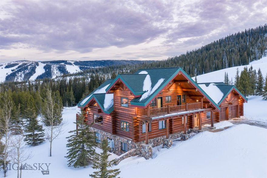 This is the kind of ski house people picture when they dream of Big Sky. An authentic log home built by Blue Ribbon Builders—one of the Big Sky's most respected builders—set directly on the side of Lone Peak, with true ski-in access right to the back door. No shuttles, no workarounds. Just step outside and ski.

The home offers 5 bedrooms, 5 bathrooms, and 5,721 square feet and is being sold turnkey. Warm, comfortable, and full of character, it’s designed to be enjoyed rather than fussed over. It has also proven itself as a high-performing short-term rental, with strong income and a loyal base of repeat guests.

The main level is centered around an open kitchen, dining, and living area with vaulted ceilings and classic log craftsmanship—perfect for gathering after a day on the mountain. The primary suite is conveniently located on this floor, along with a cozy den, an indoor hot tub, and an attached two-car garage.

Upstairs, you’ll find two spacious guest suites, each with its own en suite bath and private deck, plus a large bunk room at the end of the hall that’s ideal for hosting friends and family.

The walkout lower level feels like a second living space, offering another open entertaining area with a full kitchen, a bedroom with en suite bath, a home gym, a theater room, and a large owner’s lock-off closet for ski and bike gear.

The home sits on one of the best lots in one of Big Sky’s most desirable neighborhoods and does not require (or come with) Moonlight membership. Thoughtfully furnished with European antiques and Western artifacts, it’s ready to enjoy from day one. A private garage at the Bozeman Airport may also be included, depending on final terms.

If you’re looking for an authentic Montana ski home—true log construction, direct ski-in access, proven rental performance, and an unbeatable location—this one stands in a class of its own.