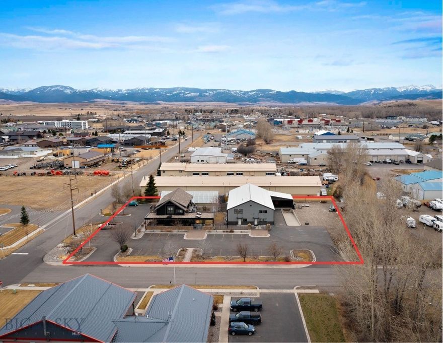 260 Ice Center Lane offers a versatile commercial opportunity with approximately 5,400 SF of warehouse space suitable for storage, distribution, and manufacturing uses. The warehouse includes a loading dock, mezzanine storage, a bathroom, washer/dryer hookups, ample power, and a 500 SF second-floor office. The property also features a separate two-level office/live-work building totaling approximately 3,678 SF with office or retail space on the main level and a fully built-out two-bedroom apartment above with a kitchen, laundry room, full bathroom, and private deck. A 3,024 SF greenhouse, courtyard space, outdoor storage, and convenient access to Bozeman, Belgrade, and Big Sky further support a range of commercial uses.