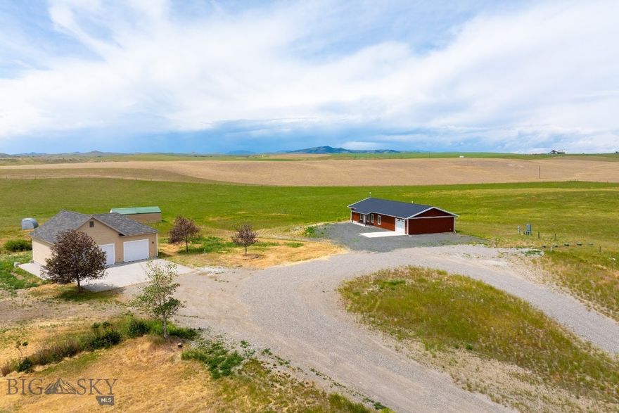 Discover the freedom of country living with this practically new, 2023-built home set on 40 acres of fenced & cross fenced land. Designed with a popular open-concept layout, this single-level 1,600 sq ft home with 2 bedrooms, 2 baths features durable Pergo flooring throughout. Spacious master bedroom has sizeable walk in closet and private bath with a walk in shower. Kitchen has inviting island and plenty of counter space with stainless steel appliances including a brand new gas stove. Laundry area includes a handy utility sink right off garage. Modern low-maintenance metal siding fits perfectly with modern conveniences like air conditioning, a new well, septic system, and a climate-controlled 2 car tandem garage. Plus, you'll love the bonus 38' x 28' detached shop-perfect for projects, storage, or extra workspace. Ready to expand? The property is already set up for future building, with a 400-amp panel and five 1,000-gallon propane tanks in place. An additional large equipment shed adds even more flexibility. Upgrades include a water filtration & security system. Room for horses, cattle, chickens or whatever your dream lifestyle holds. Take in sweeping views of the rolling countryside and distant mountains. Home is part of minor subdivision with minimal covenants and all other parcels are 20 acres. Located just off Hwy 287 N, you're perfectly situated near Three Forks, Bozeman, Butte, Helena and all sorts of outdoor recreation. Covenants and Warranty Deed appear to allow for property to be split into two 20 acre parcels. Buyer to due all their own due diligence. Convenient RV parking with power, water and clean out by garage. Don't miss this great opportunity, call your favorite realtor for a tour today.